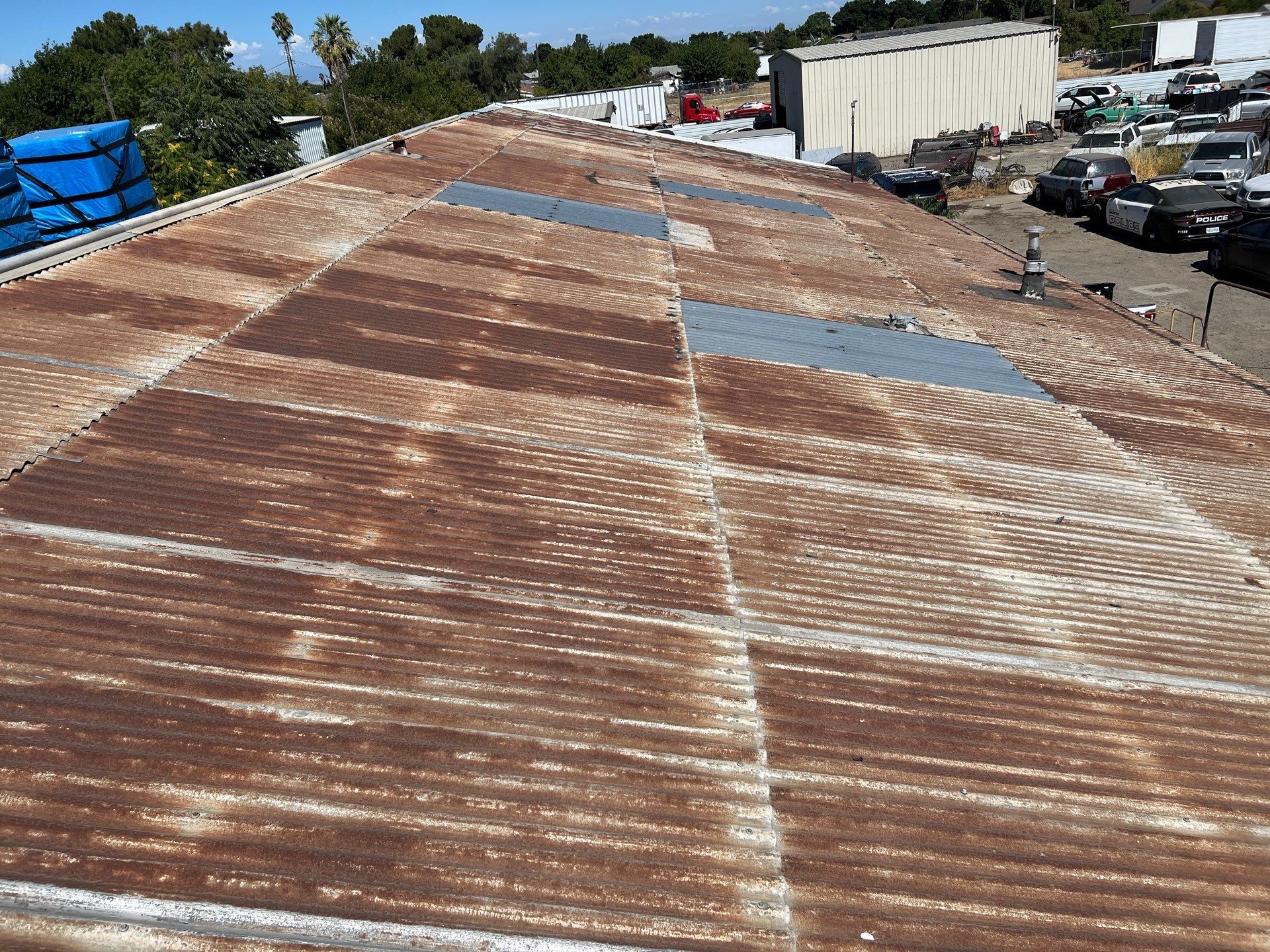 Spray foam and coatings using Conklin Benchmark/ PUMA XL acrylic coatings over metal and foam by Straight Edge Roofing Inc