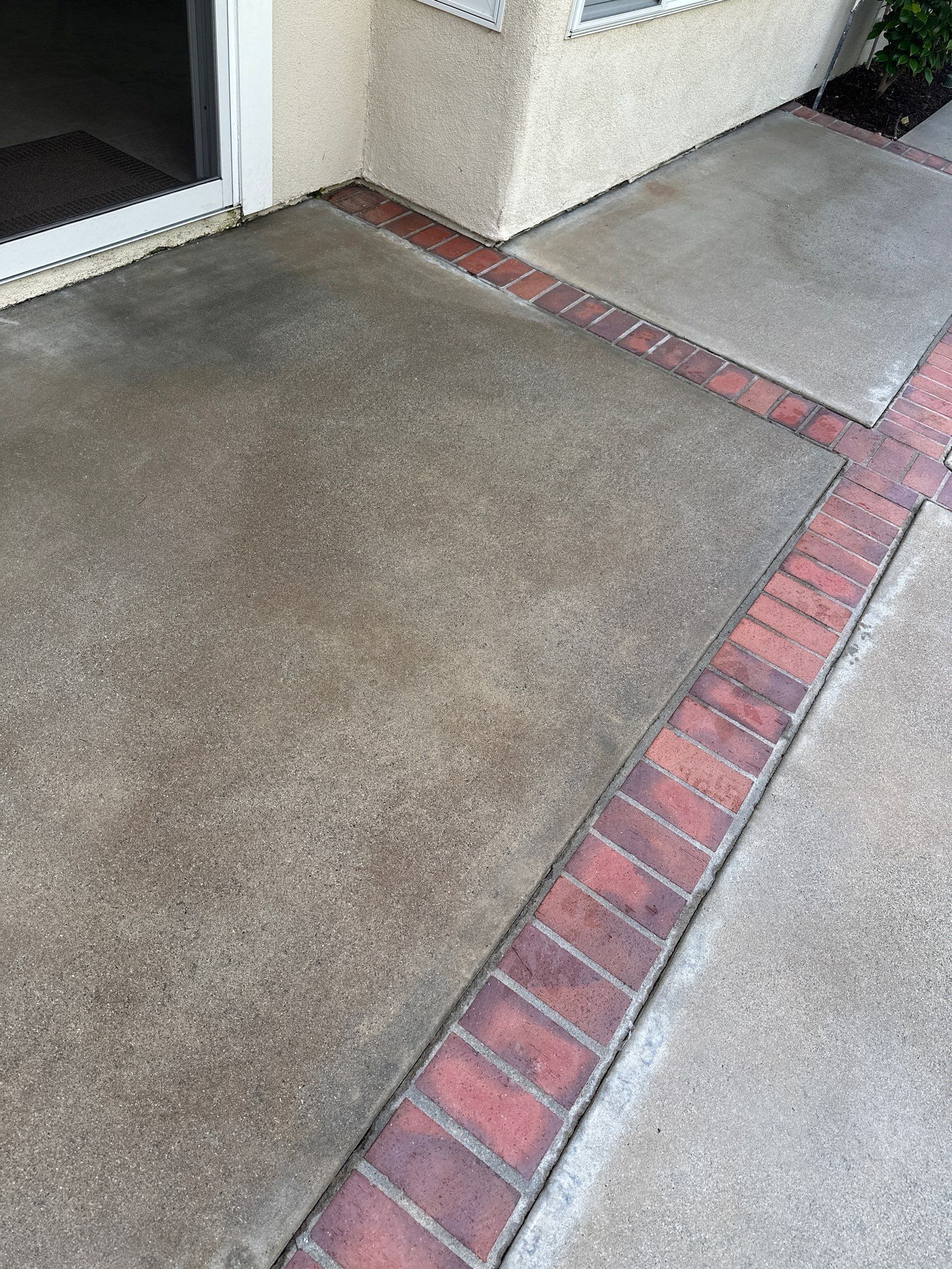 Surface cleaning pressure washing in Orange County on patio, walkways, and driveway by Property Cleaning Experts, LLC
