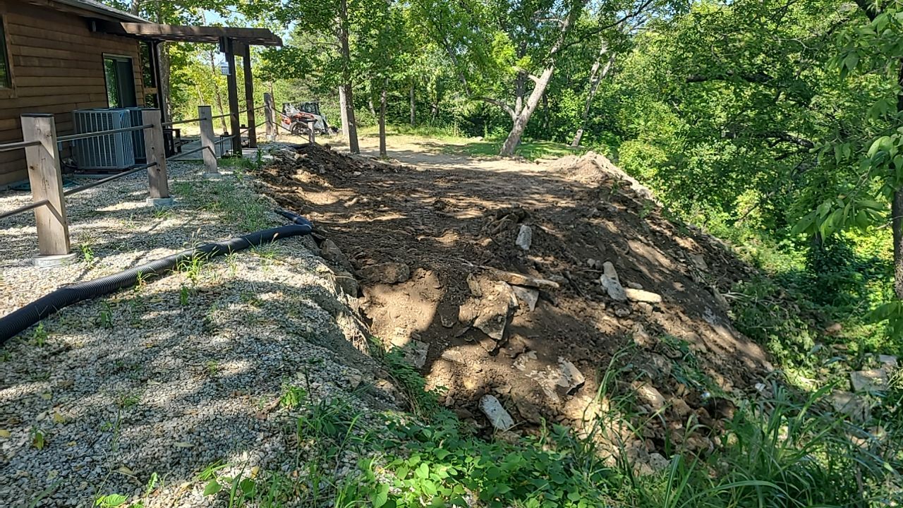 Supporting back of home with backfill at edge of steep creek by LAND ESCAPES LLC