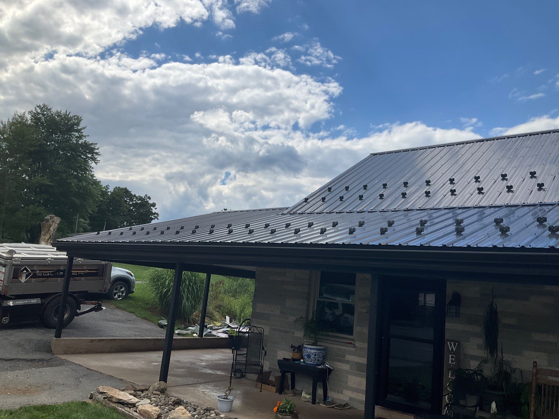 Metal Roofing, Board & Batten Siding, and Entry Door Transformation by Esh Builders