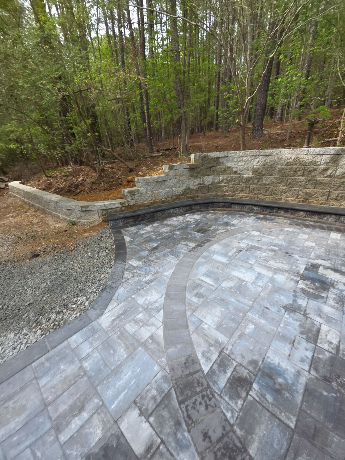 Pittsboro Outdoor Living Transformation – Retaining Wall, Paver Patio & Elevated Deck by Elite Remodeling and Design LLC