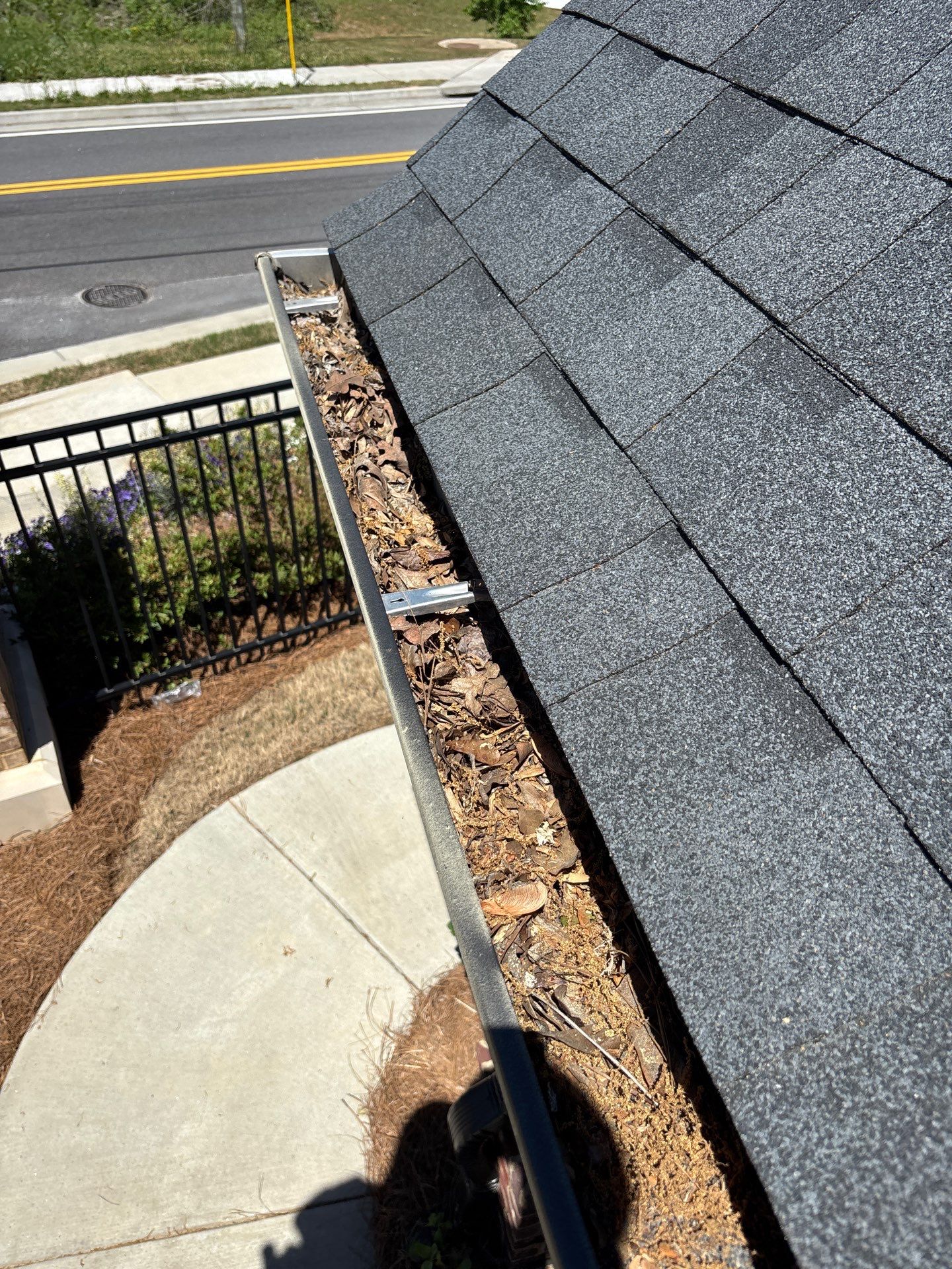 Commercial gutter cleaning Duluth & Gwinnett, before photo with filled gutters