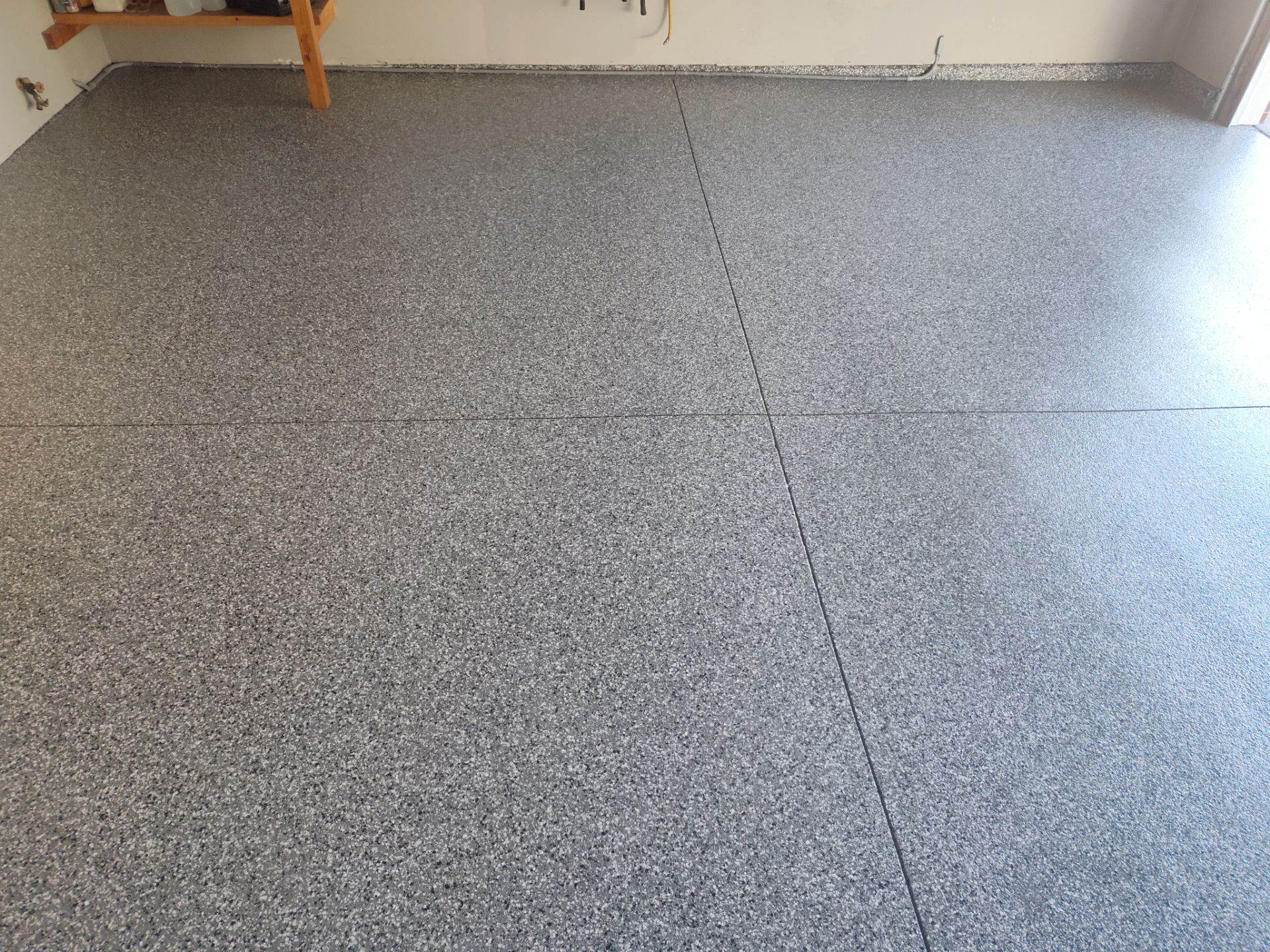 Close Up View of This Customer's New Flake Coating by Revival Concrete Coatings