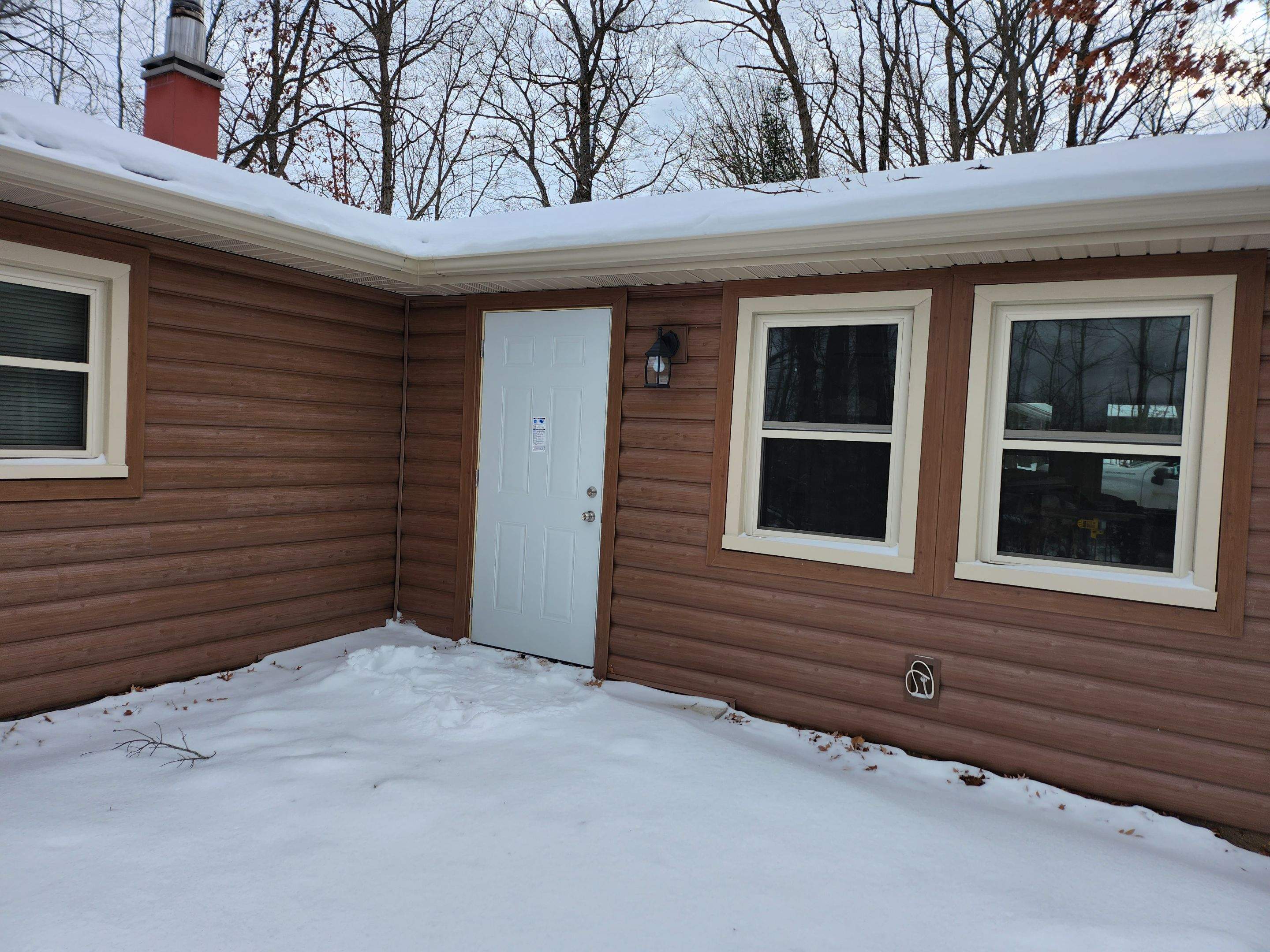 New addition and log siding by Energy Plus Home Improvements