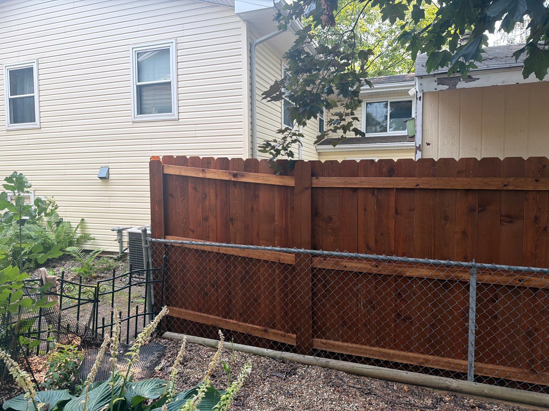 Pecan Cedar Privacy Fence Installation with Scalloped Top in Cedar Falls by Perfect Picket Fence and Stain
