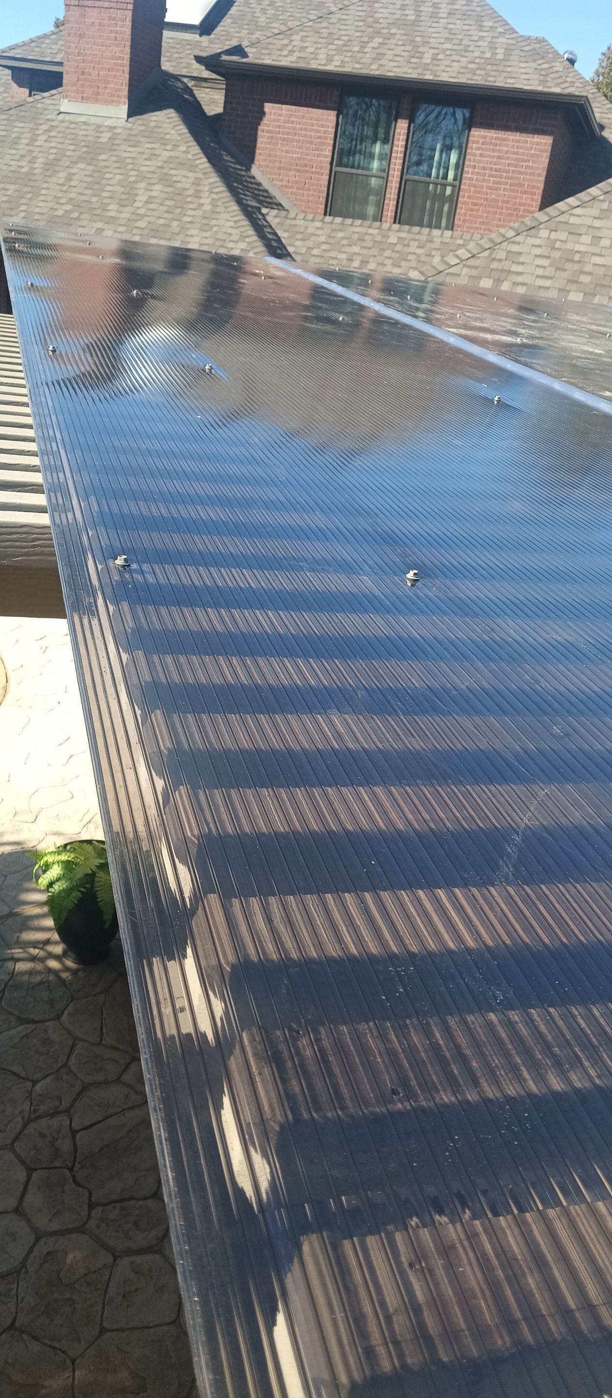 Polygal twin wall roofing system using 8mm bronze twin wall polygal by Grizzly Fence And Patio