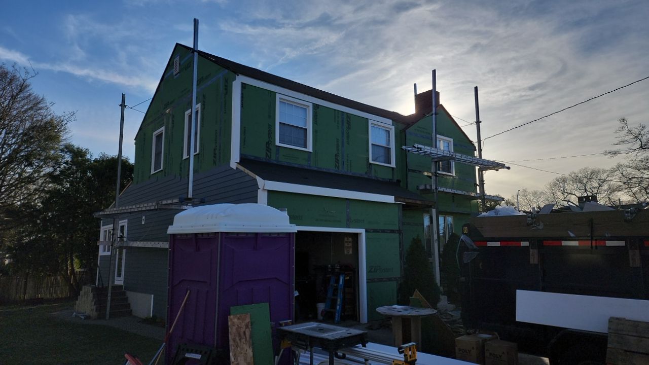 James Hardie siding, new metal roof and couple windows being installed. by UBrothers Construction