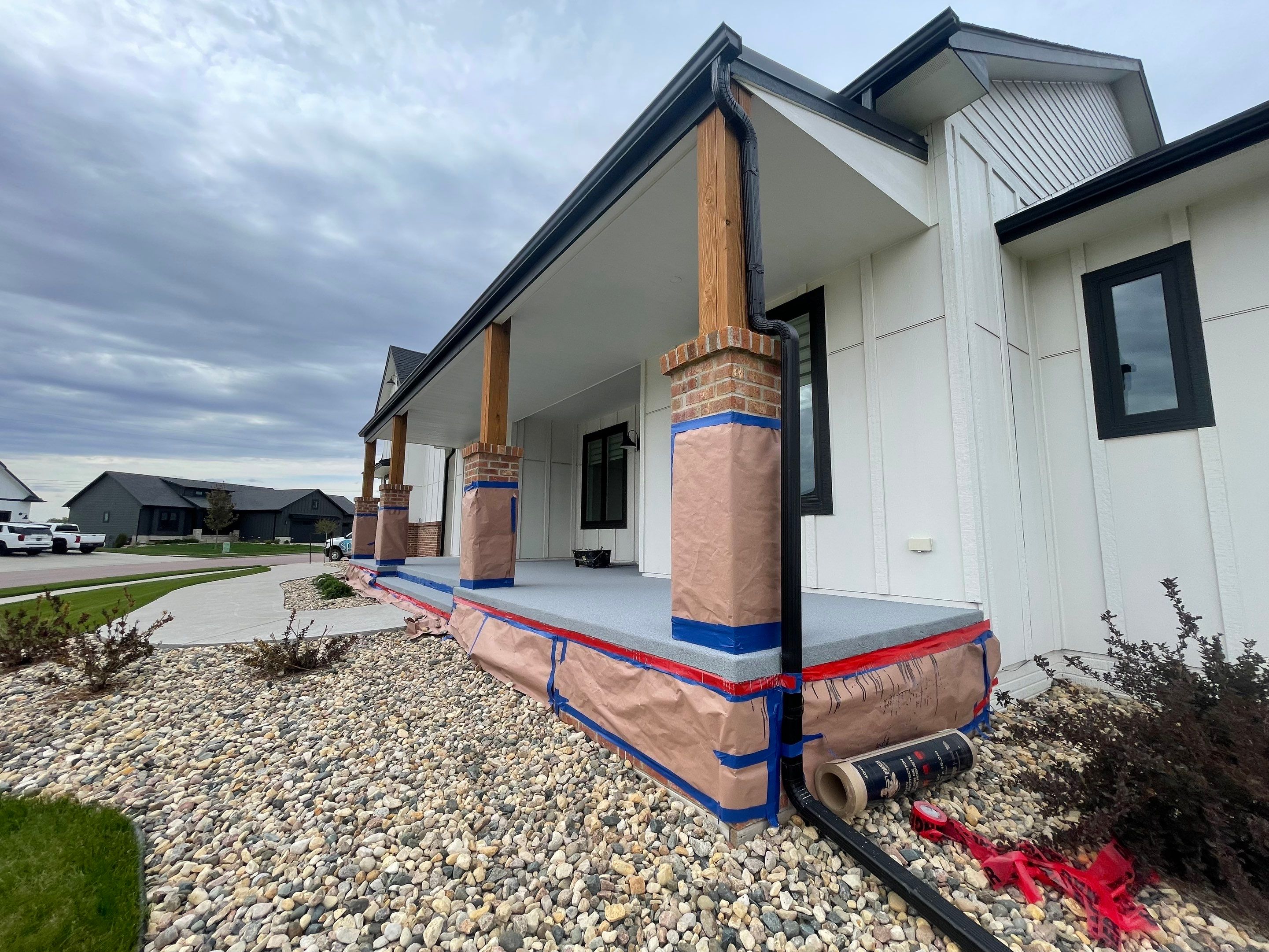 Grey Speckled Concrete Porch Coating for Sioux Falls Home by Select Painting, Coatings & Garage Cabinets