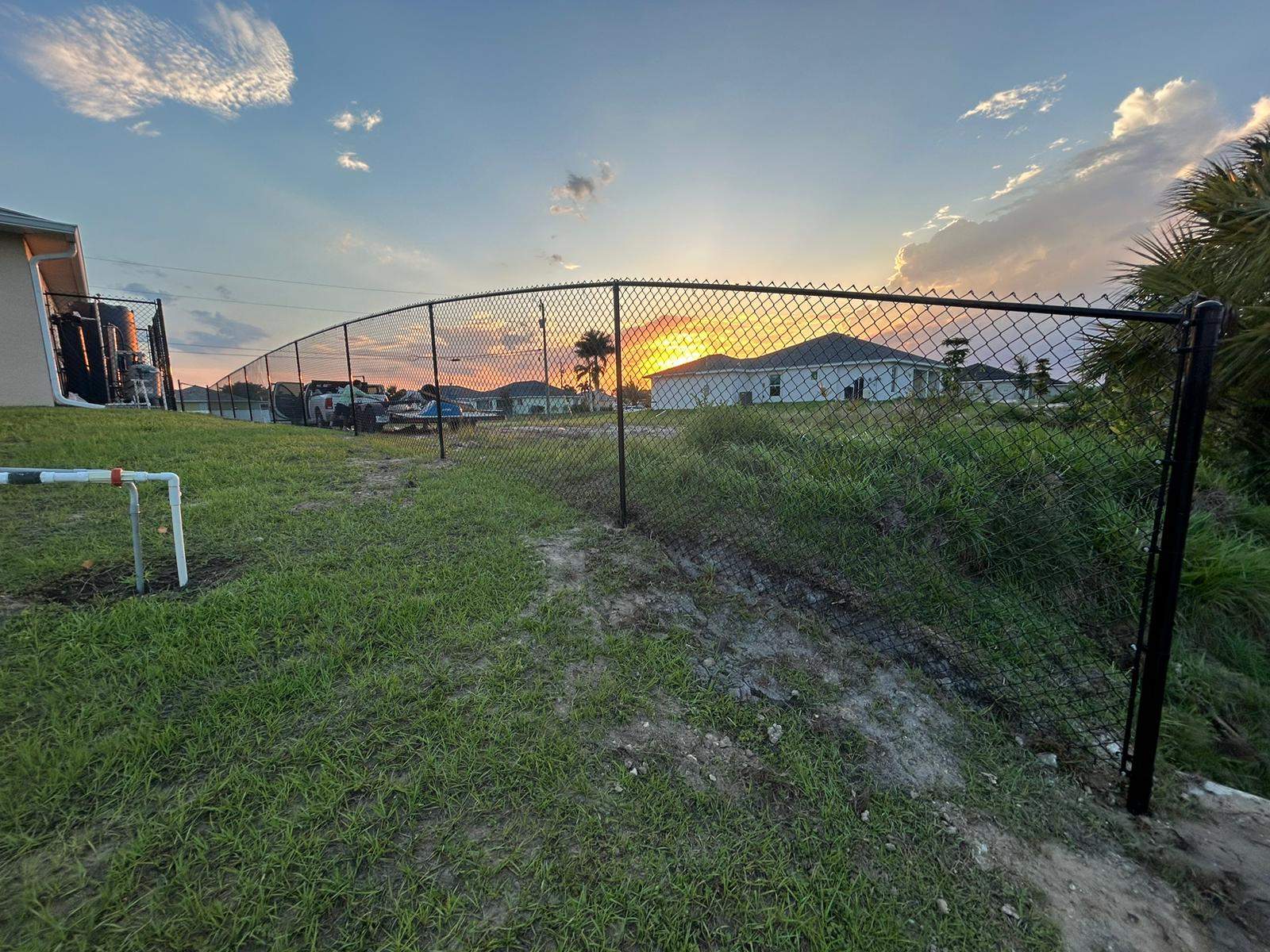 Black Chain Link Perimeter Fence and Utility Enclosure in Cape Coral by True Fence LLC