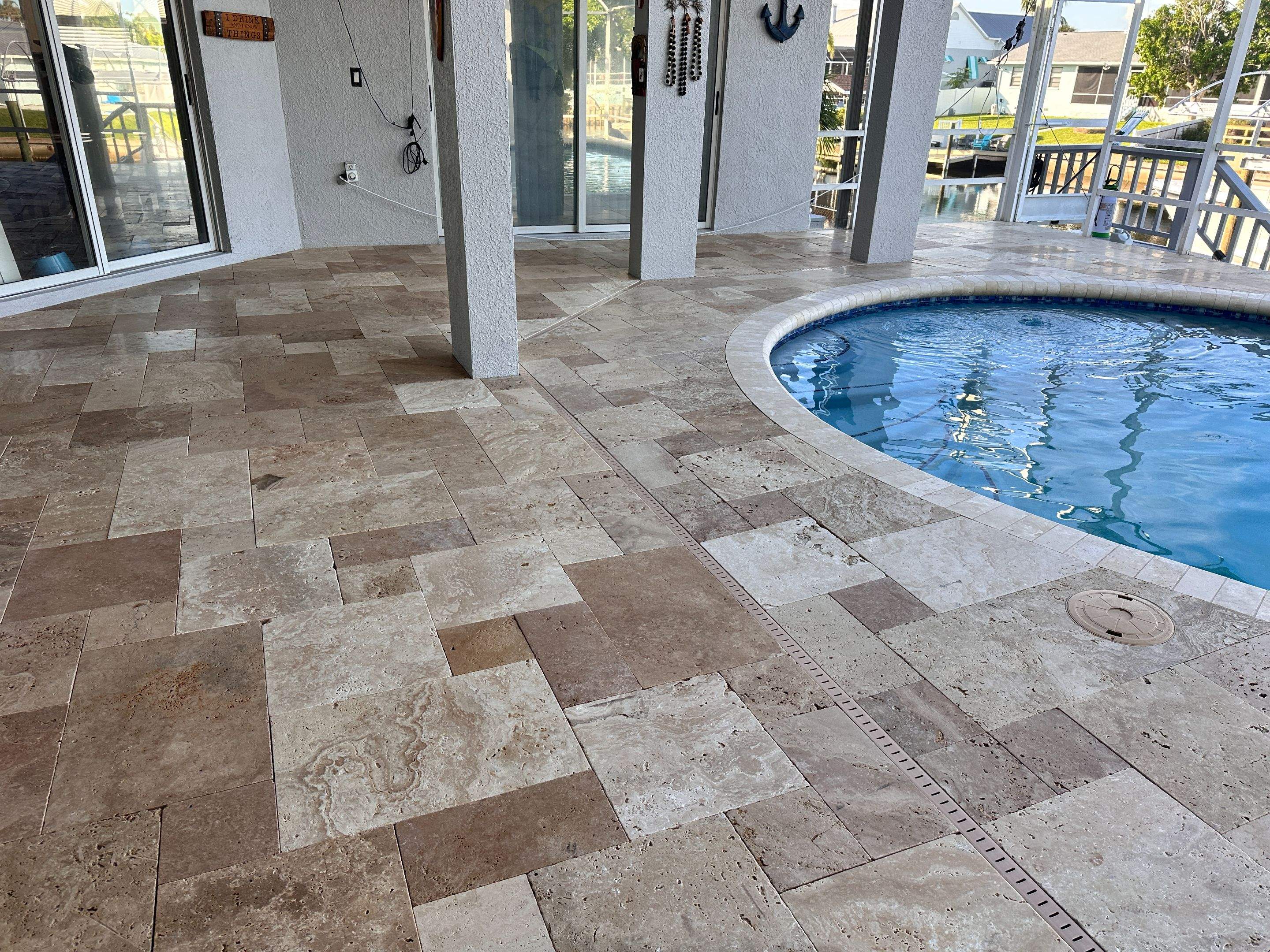 Travertine Sealing and Stripping for a Waterfront Pool Deck in Apollo Beach by Supreme Paver Experts