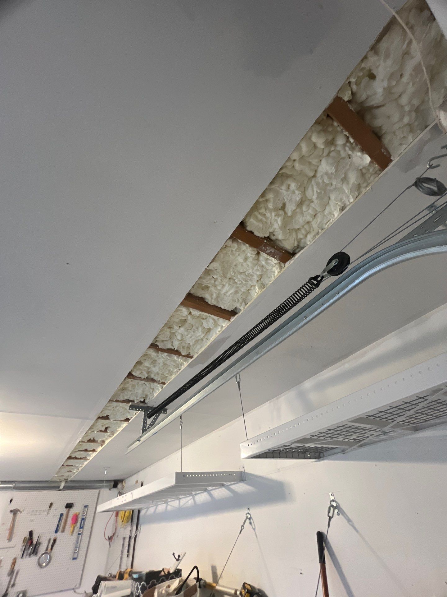 Garage ceiling using open cell spray foam by NYS Foam & Energy
