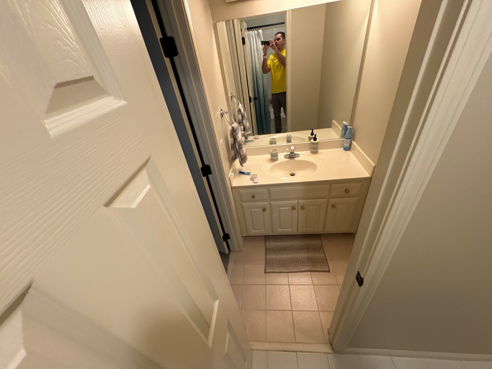 Tub retile, floor, vanities, mirror, and lights by Prudencio