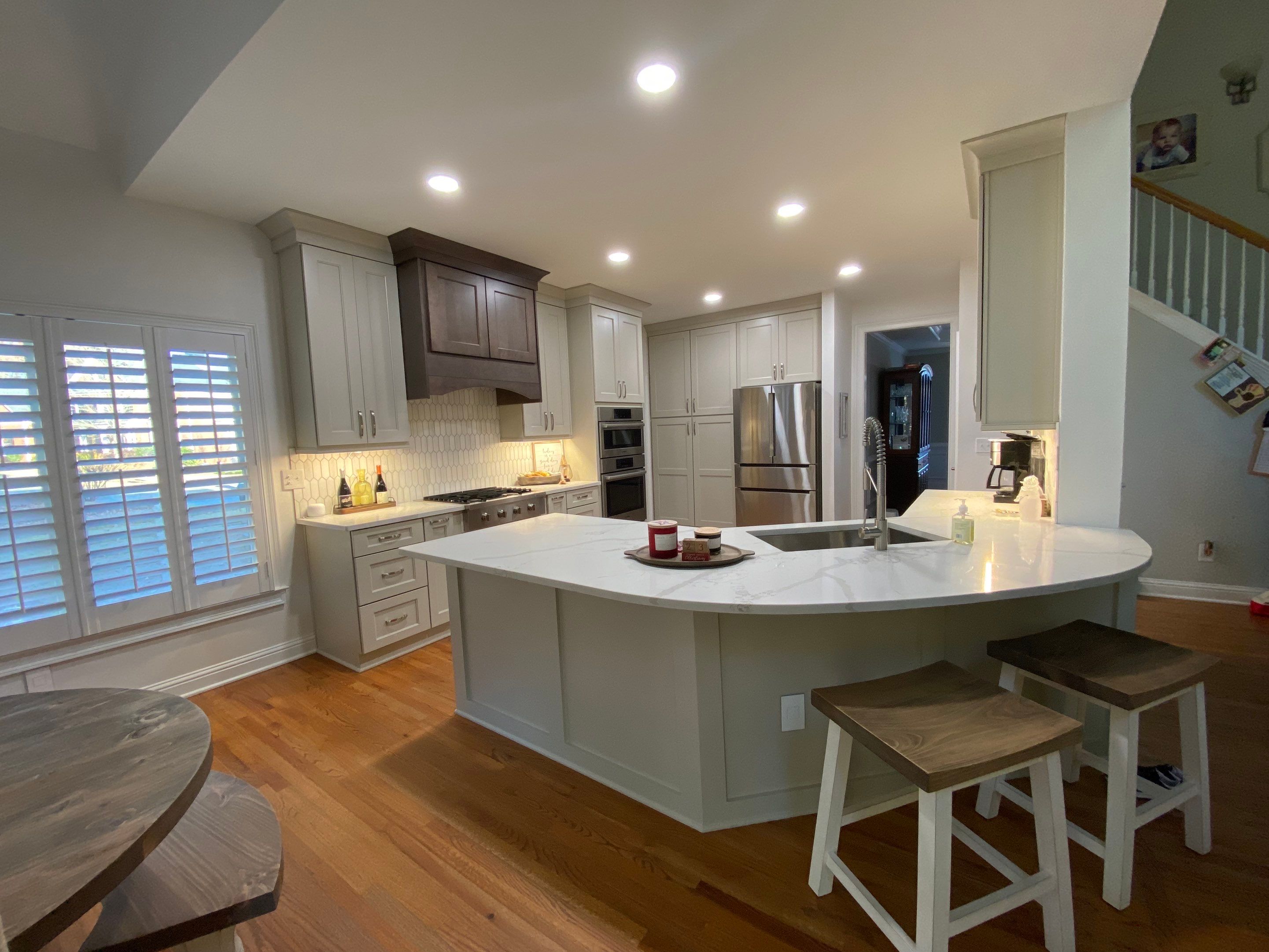 Modern Kitchen Remodeling with Quartz Island and Custom Vent Hood in Woodstock by Swift Home Renovations