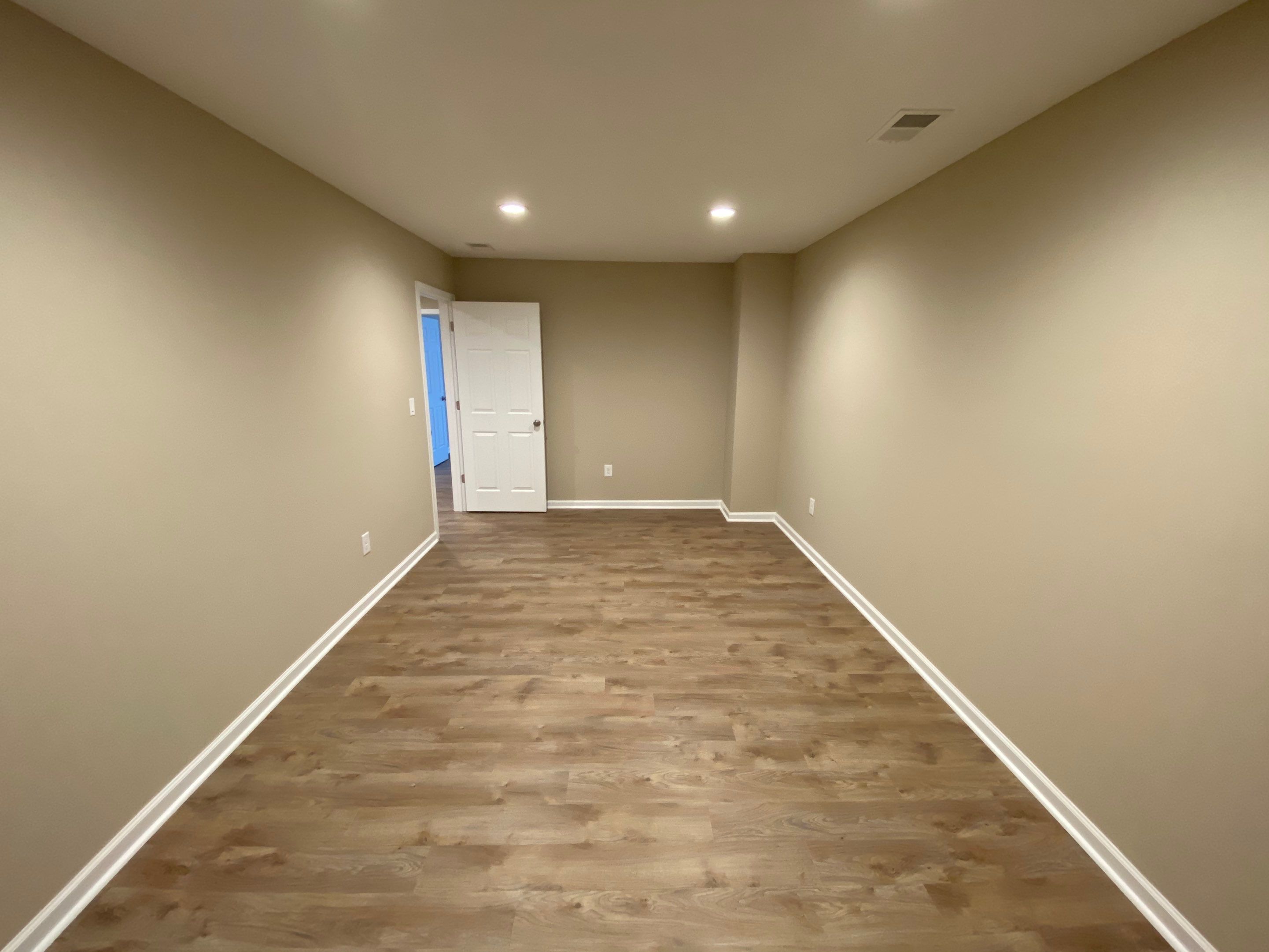 Acworth Basement Transformation With Wet Bar and Stone Fireplace by Swift Home Renovations