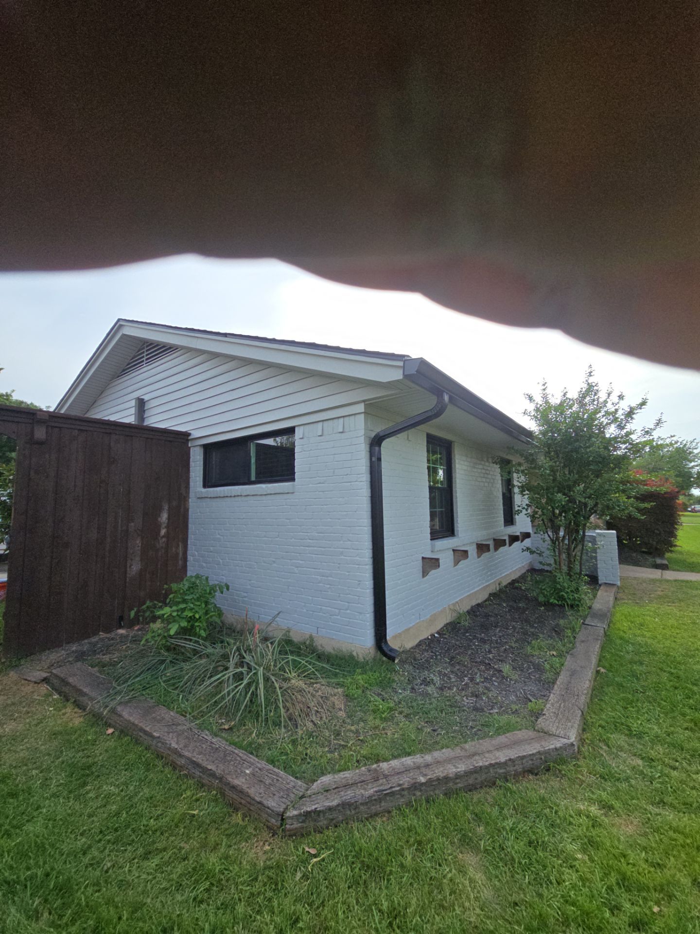 Exterior Home Paint Project with Different Surfaces by SLM General Contractors & Roofing