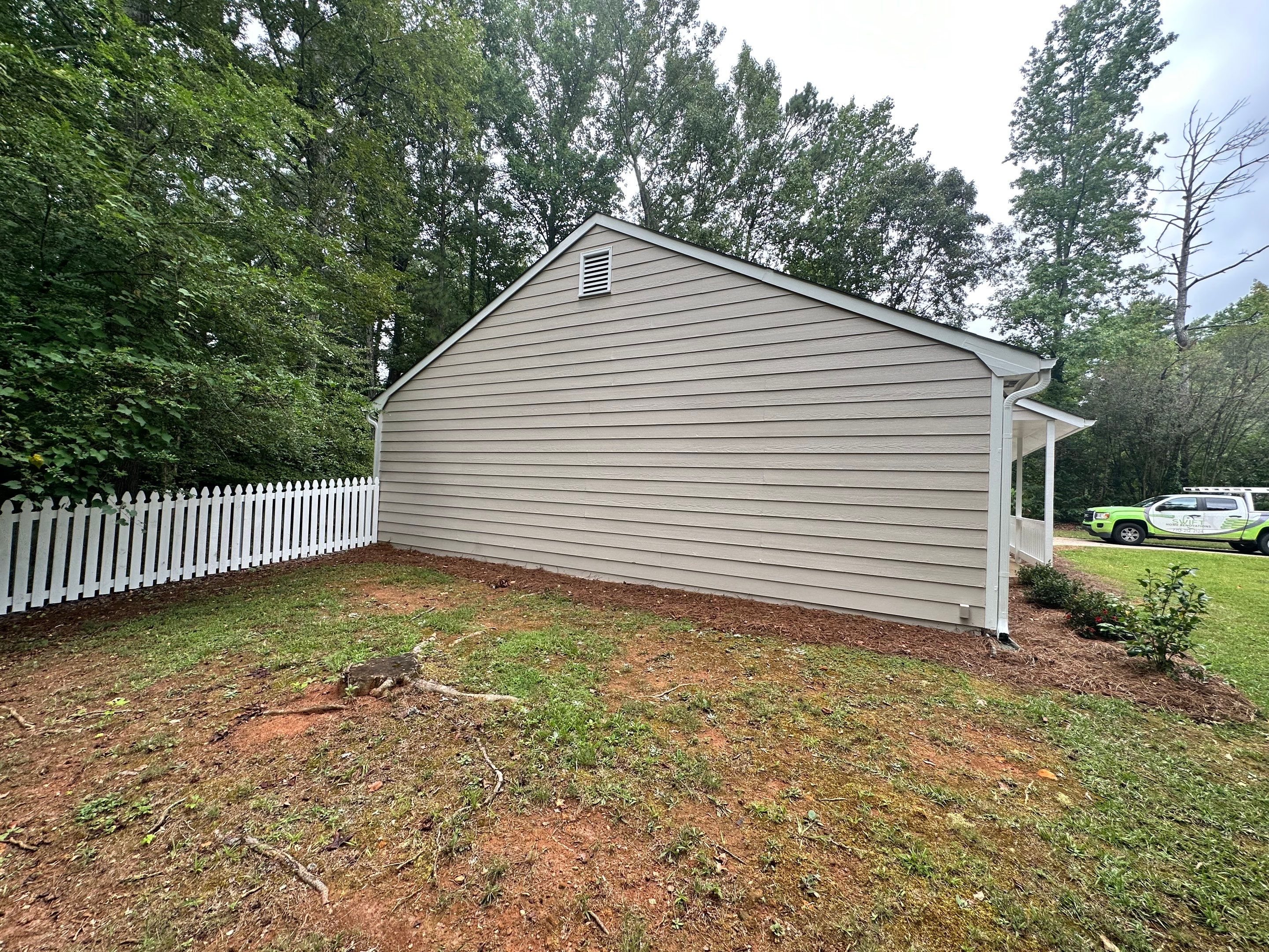 Exterior Siding Painting and Picket Fence Installation in Powder Springs by Swift Home Renovations
