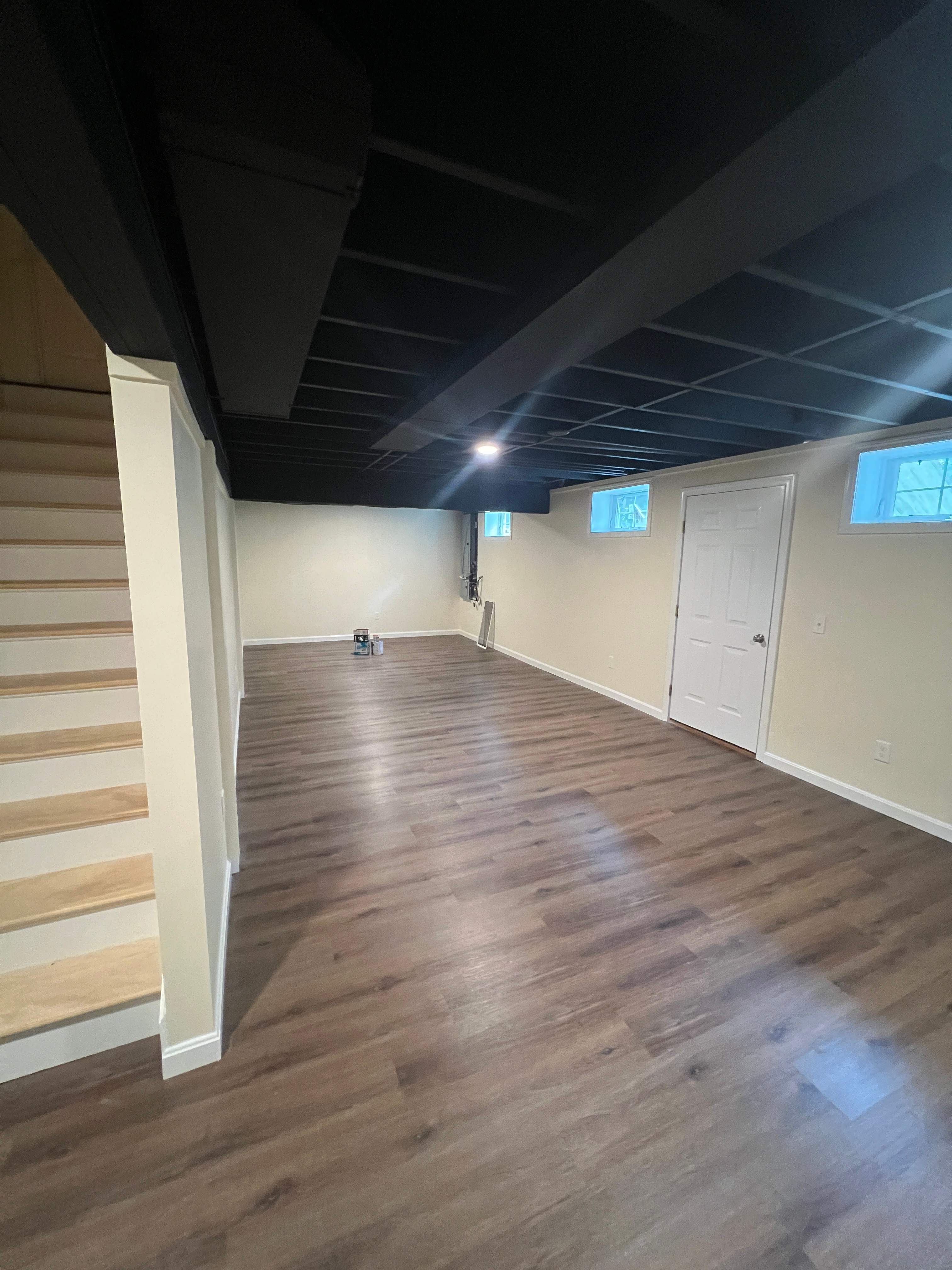Basement Remodel w/ LVP Flooring & Exposed Ceiling by Chagnon Building & Remodeling LLC