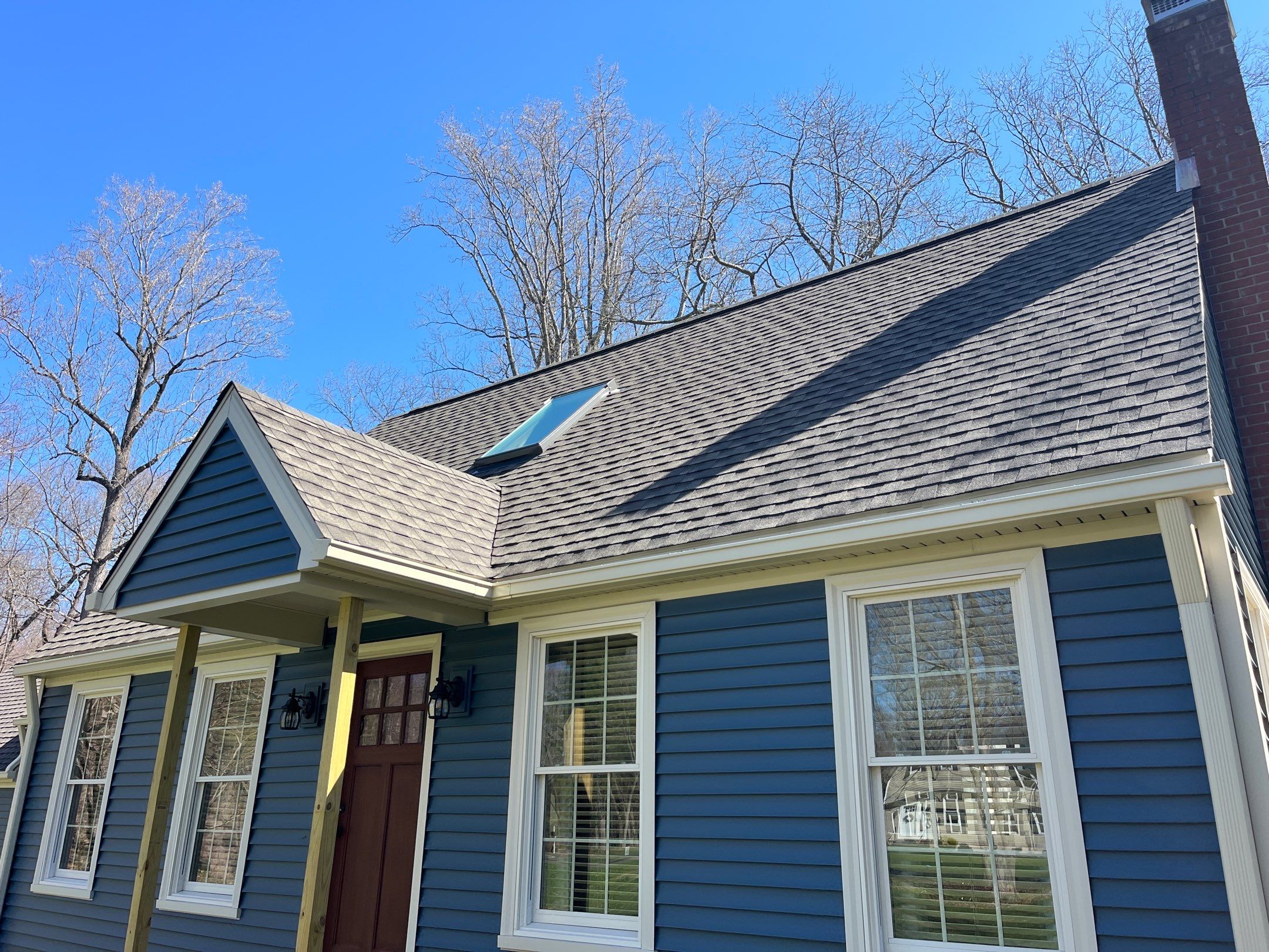 Asphalt shingles meet sleek siding in Guilford. by DiGiorgi Roofing and Siding Inc