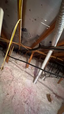Attic interior showing insulation and ductwork.
