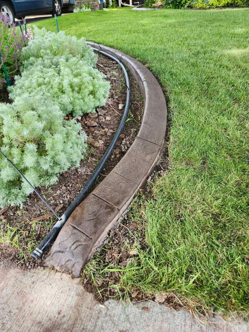 Decorative Stamped Concrete Landscape Edging Installation in Medicine Hat by Pump it Up Concrete Jacking