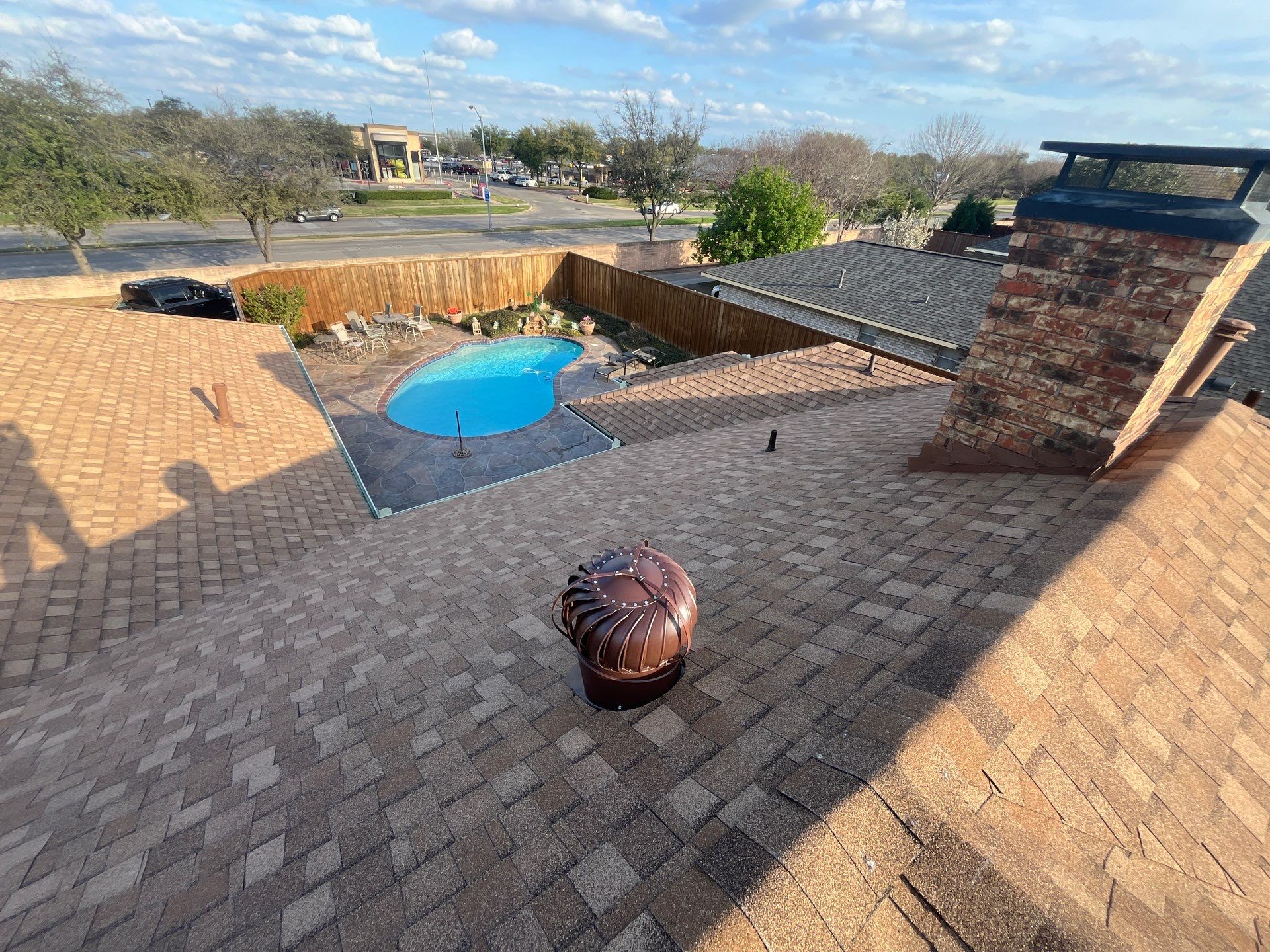 Medium brown brick with Tamko Rustic Cedar by Tejas Roofworks + Restoration