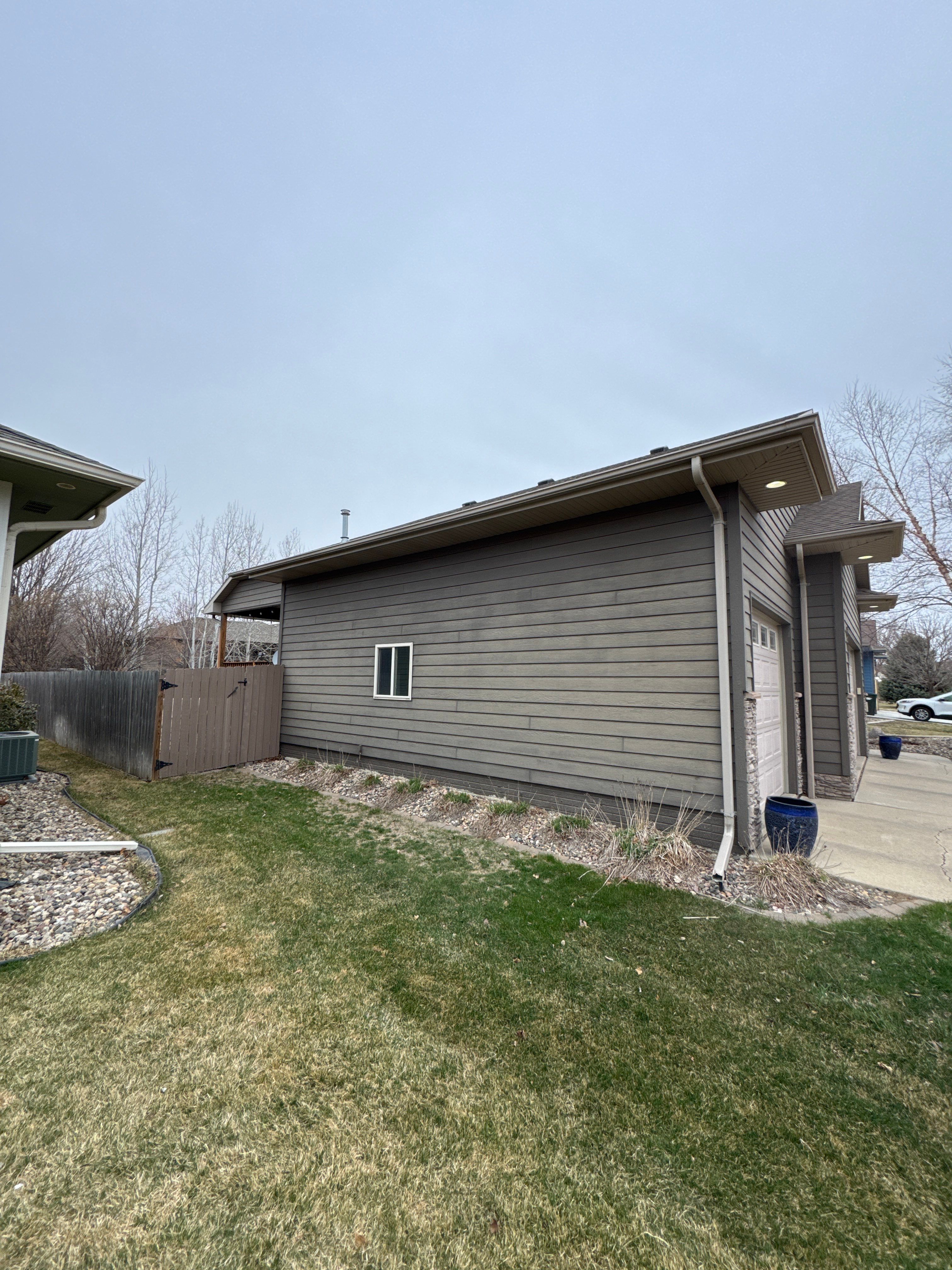 Sioux Falls Residential Exterior Update and Flagstone Pool Deck by Select Painting, Coatings & Garage Cabinets