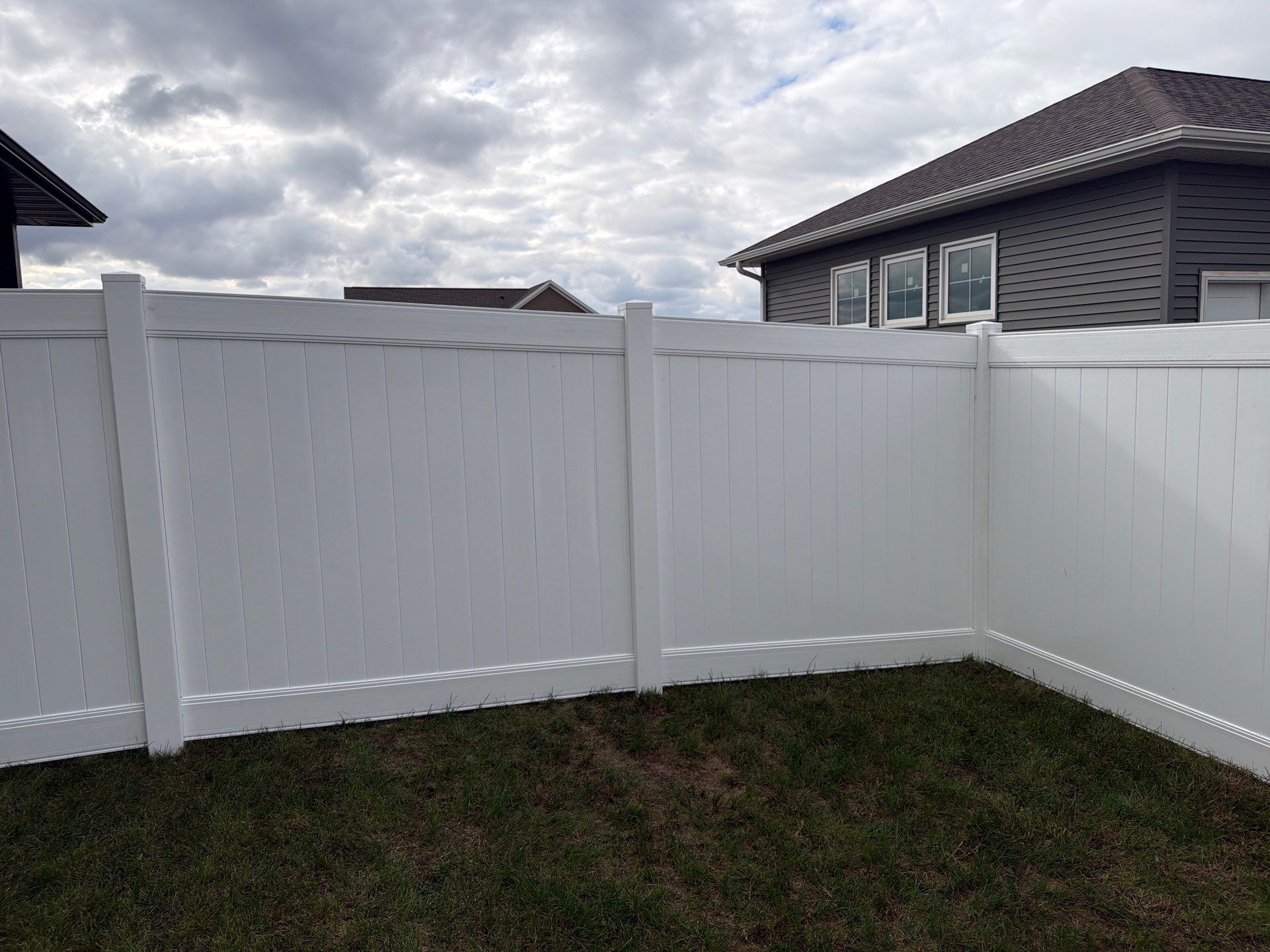 Residential White Vinyl Privacy Fence Installation in Janesville by Perfect Picket Fence and Stain