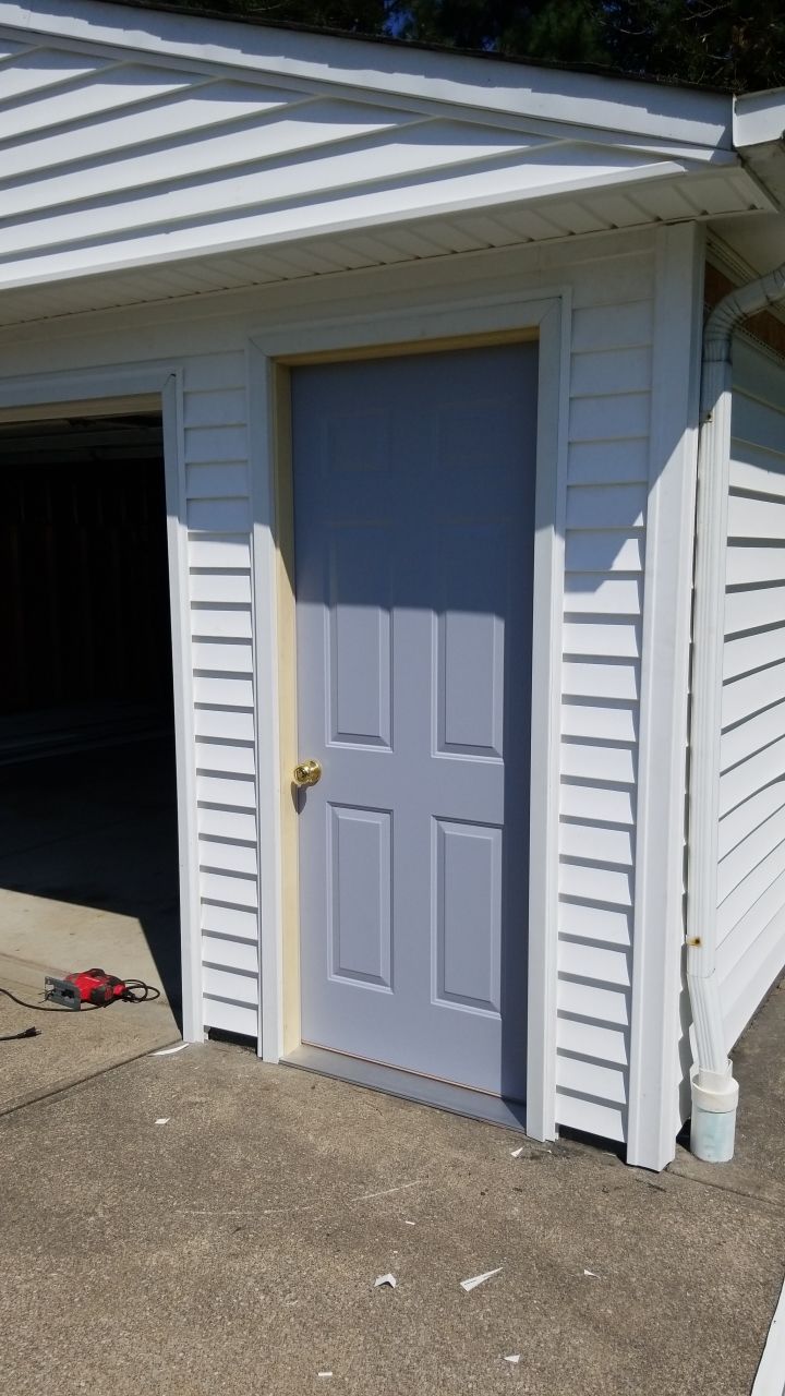 Siding Installation using Norandex woodsman dl-5 white woodgrain vinyl by Absolute Roofing and Construction