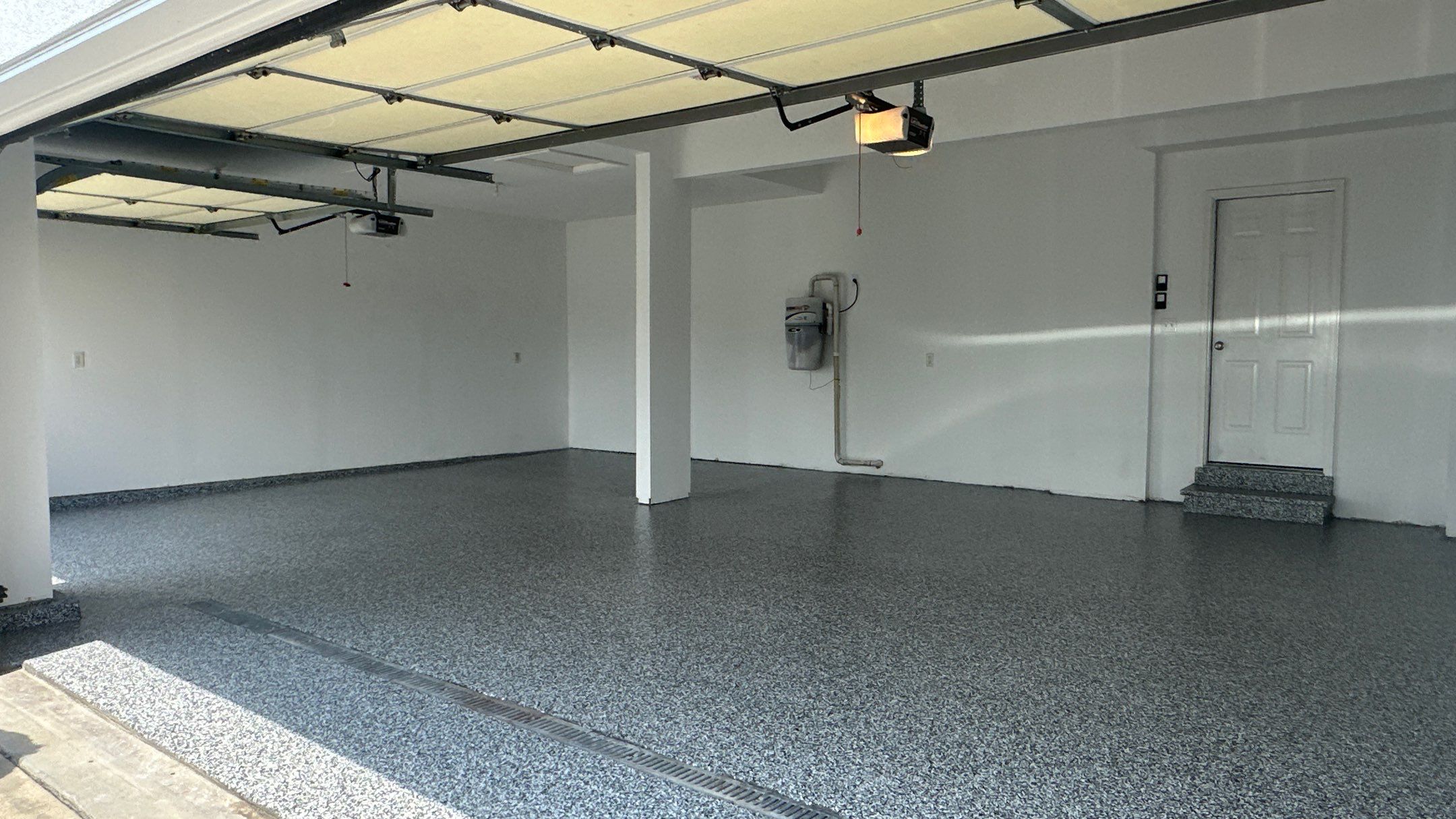 Laura B. garage transformation with a new floor and garage storage  by Banner Garage