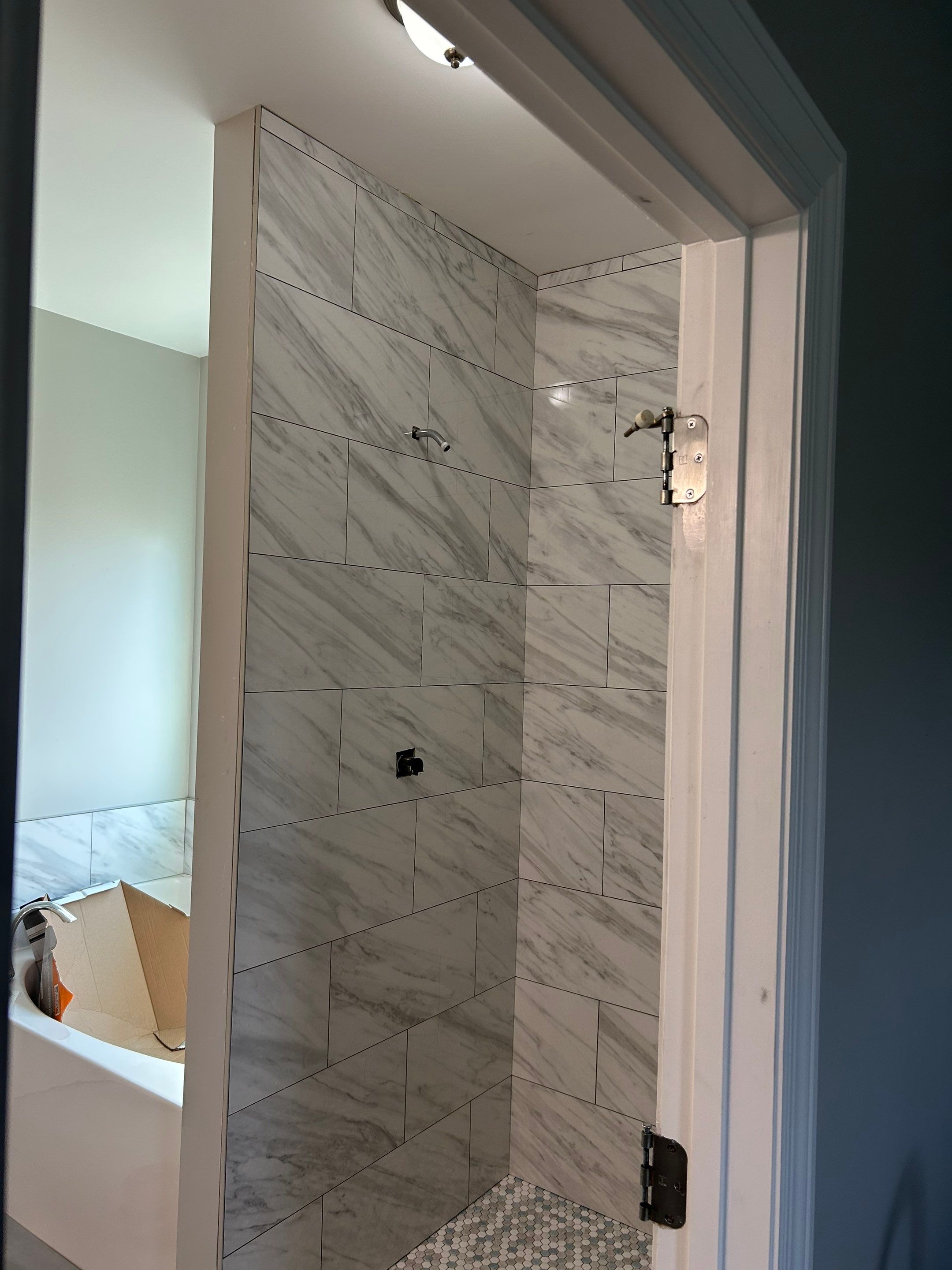 Tile shower remodel and heated floors by Footprints Floors of Nashville