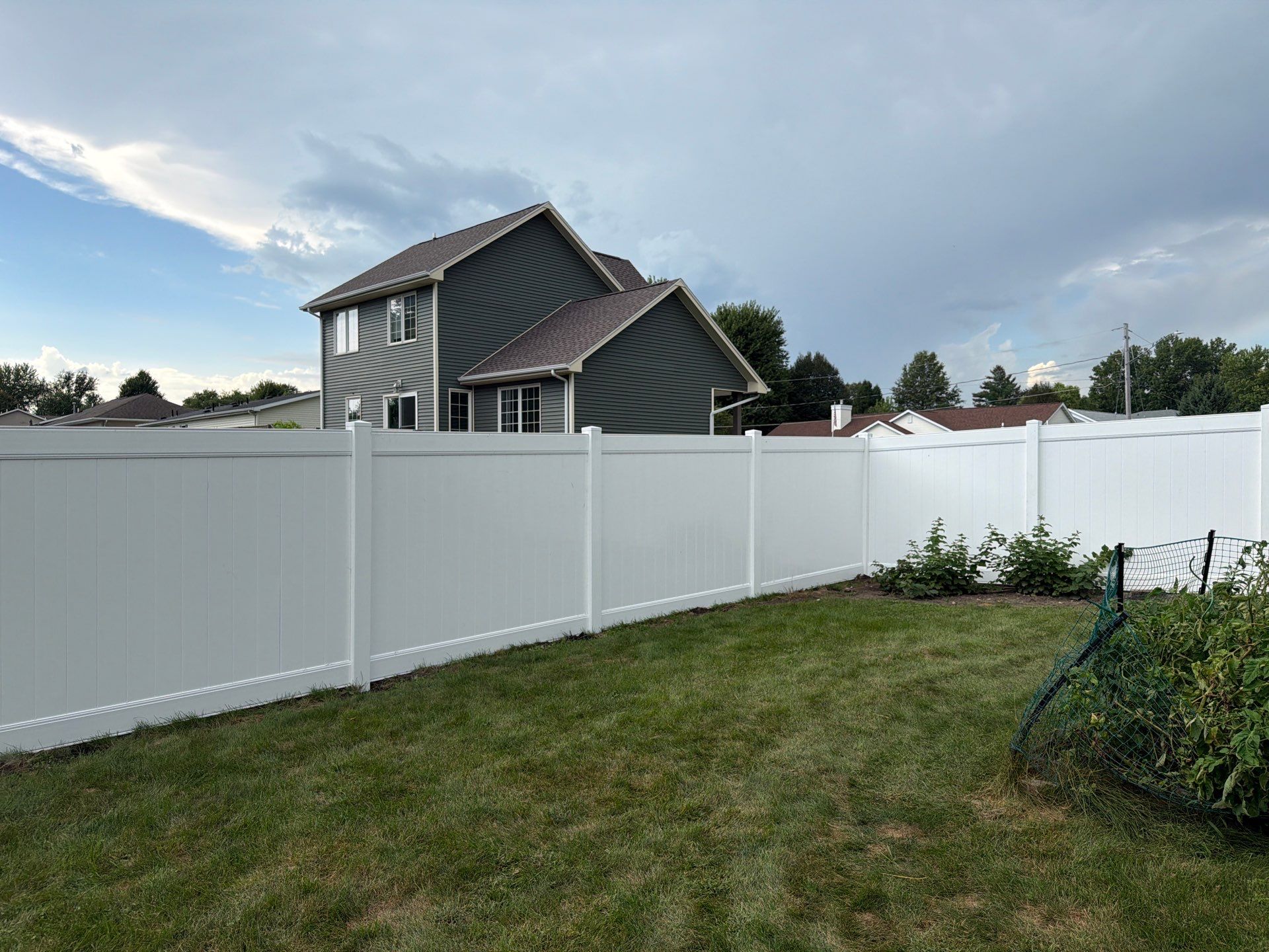 White Vinyl Privacy Fence Installation in Raymond, IA by Perfect Picket Fence and Stain