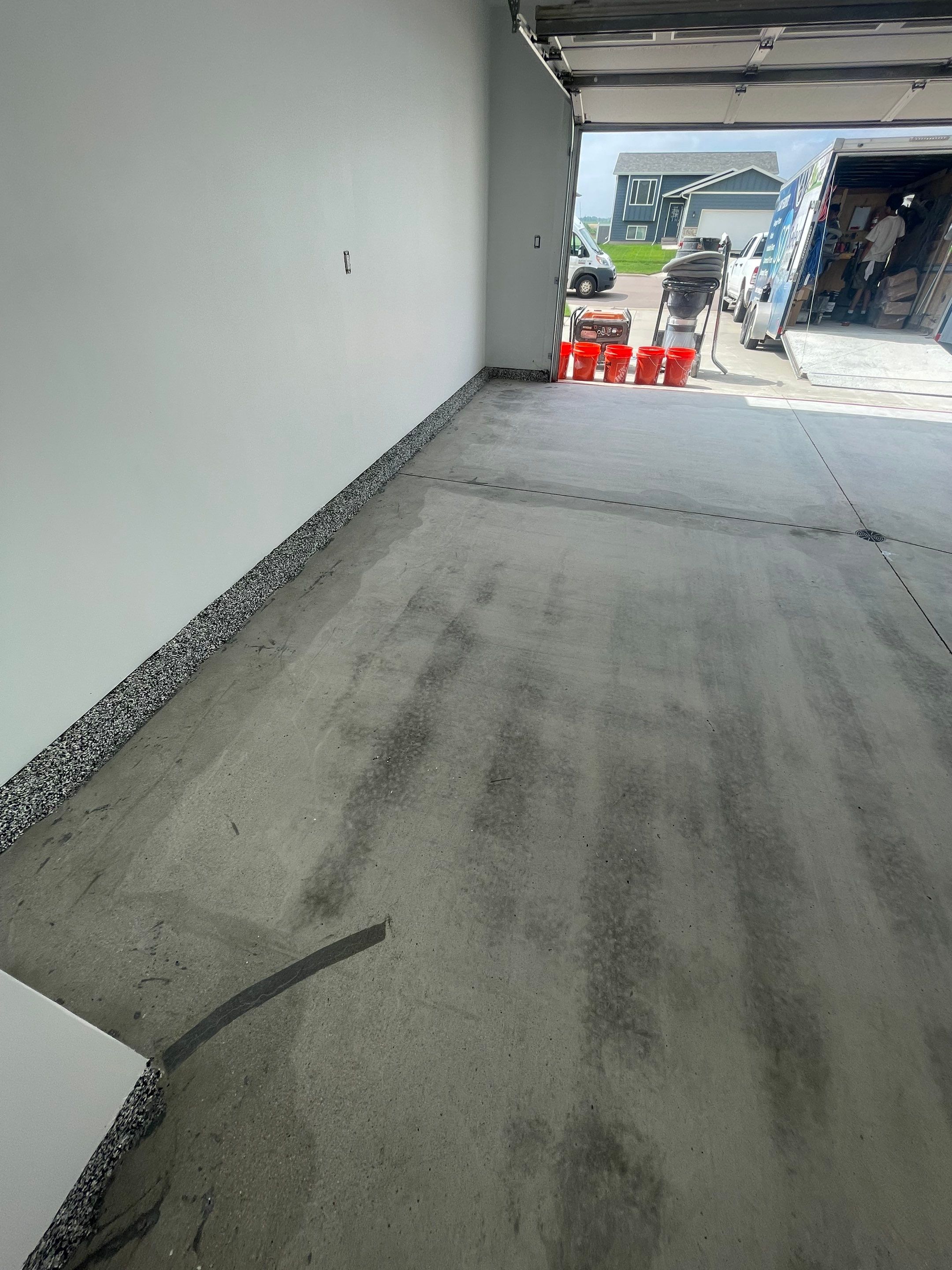 Grey Flake Epoxy Garage Floor Coating in Sioux Falls by Select Painting, Coatings & Garage Cabinets