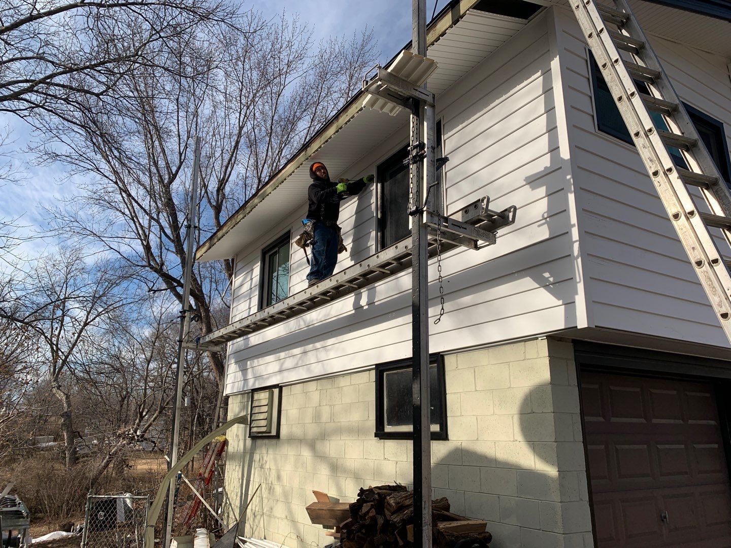 White Craneboard Siding and Heartland Window Installation in Parkville by EEC Windows, Siding & Roofing