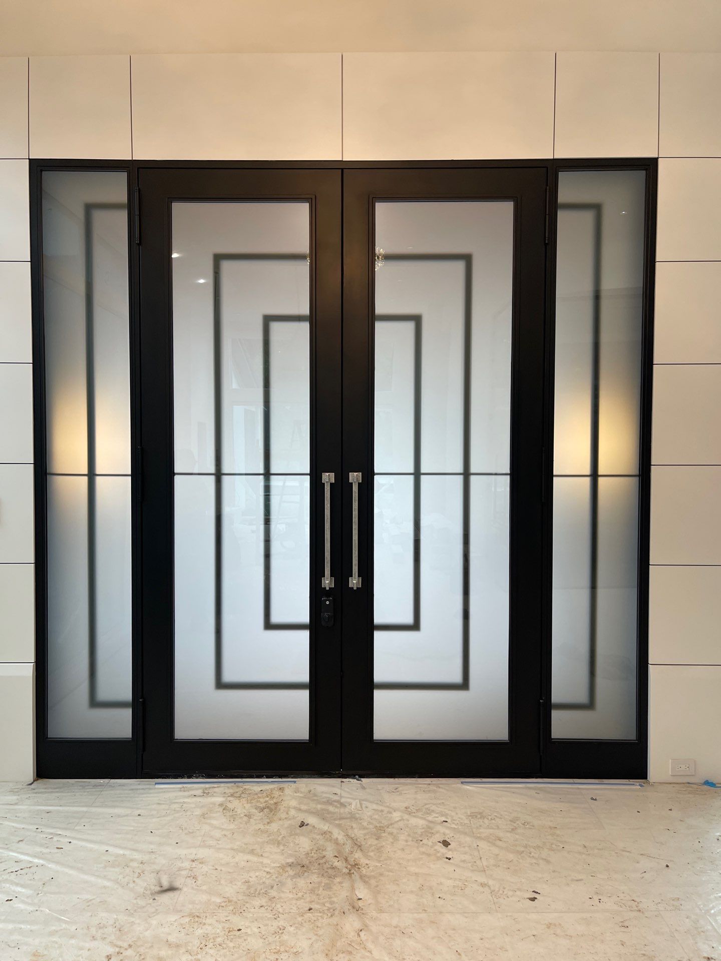 Modern Metal and Glass Entryway Installation with Custom Hardware Finishing in Dallas by Solara Custom Living