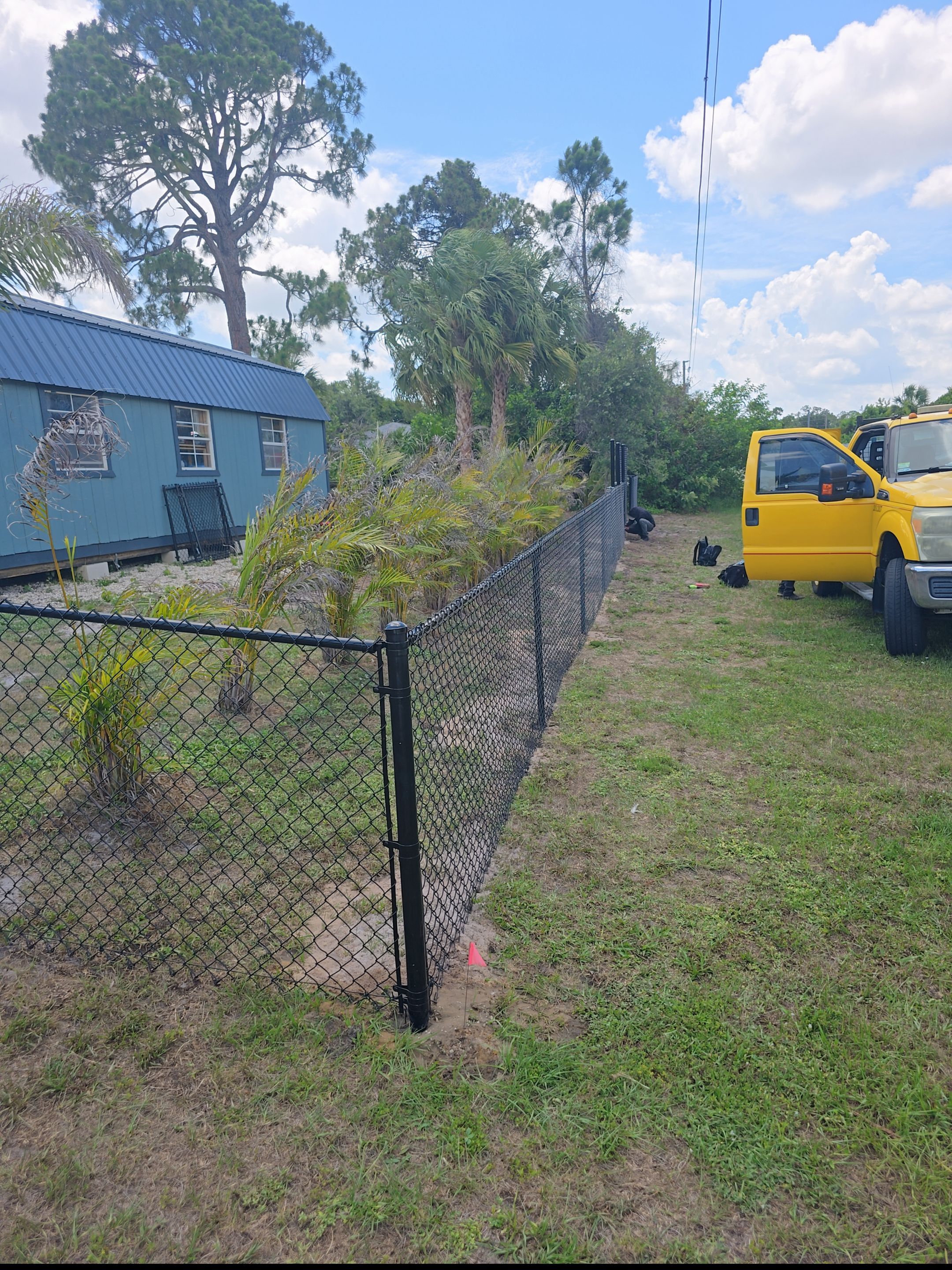Black Vinyl-Coated Chain Link Fence and Rolling Gate Installation in North Port by True Fence LLC