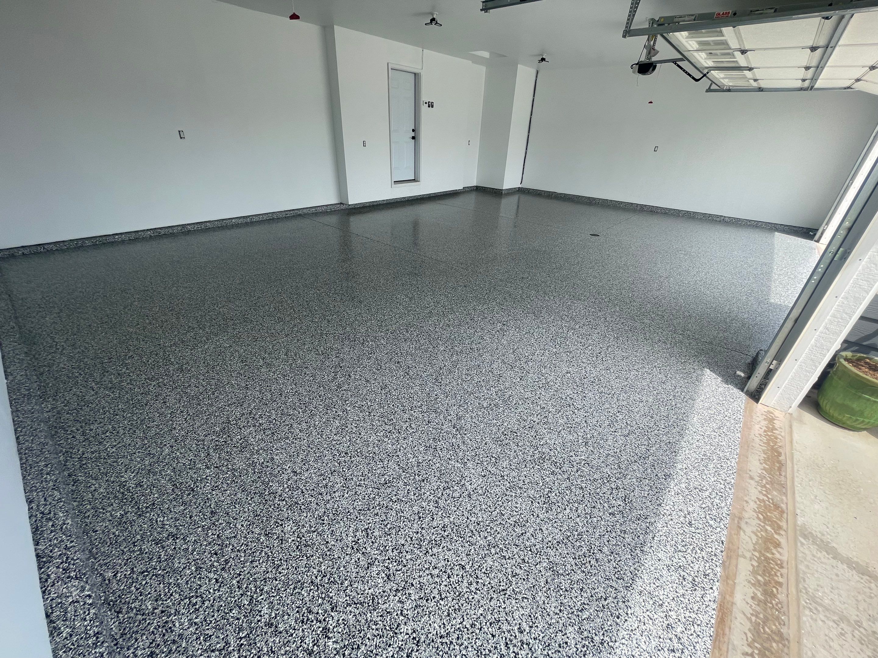 Grey Flake Epoxy Garage Floor Coating in Sioux Falls by Select Painting, Coatings & Garage Cabinets