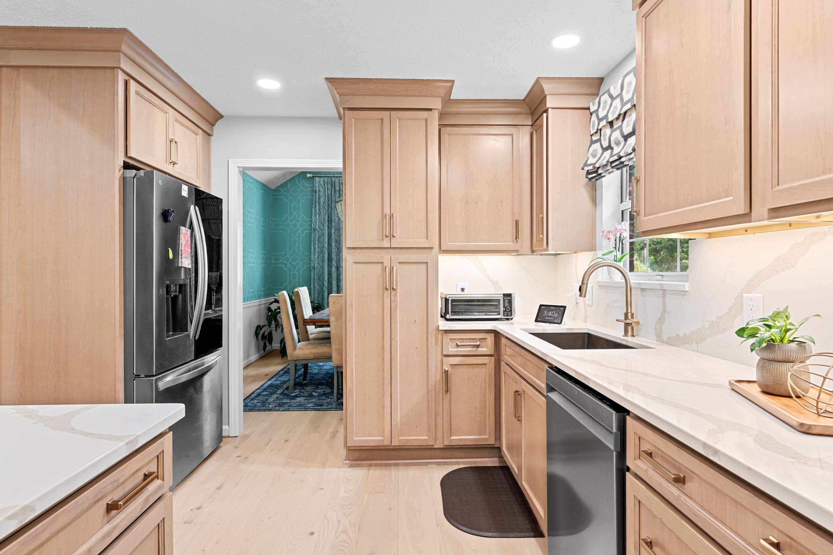 Modern Kitchen Remodel Featuring Quartz Backsplash, under cabinet lighintg, and a coffee bar in Mt. Juliet Tennessee by DeRo Renovations,LLC