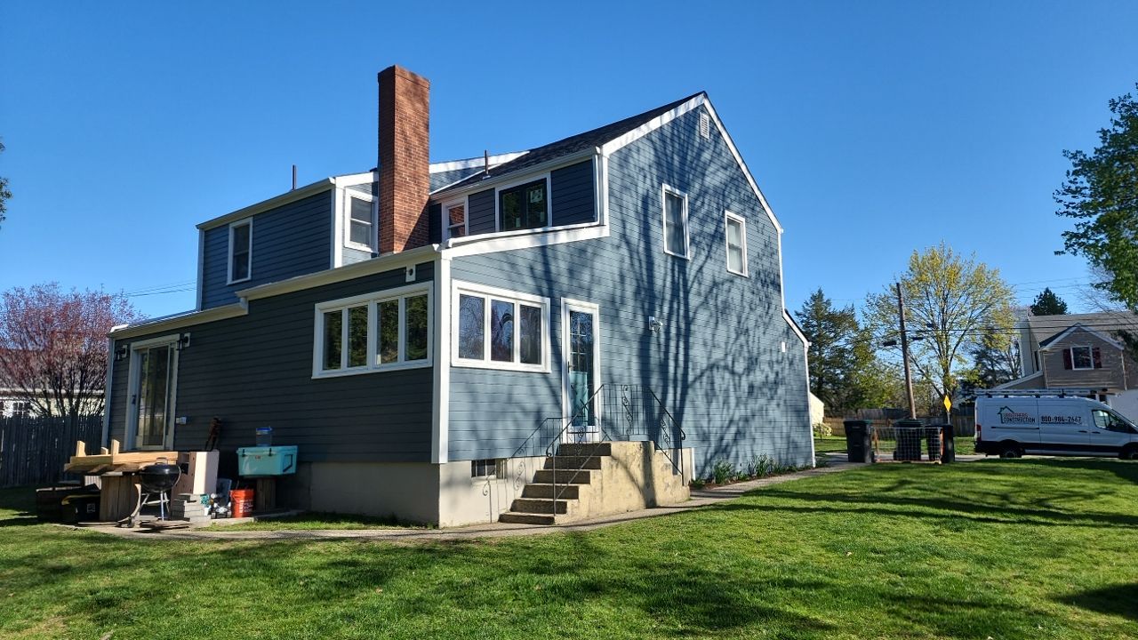 James Hardie siding, new metal roof and couple windows being installed. by UBrothers Construction