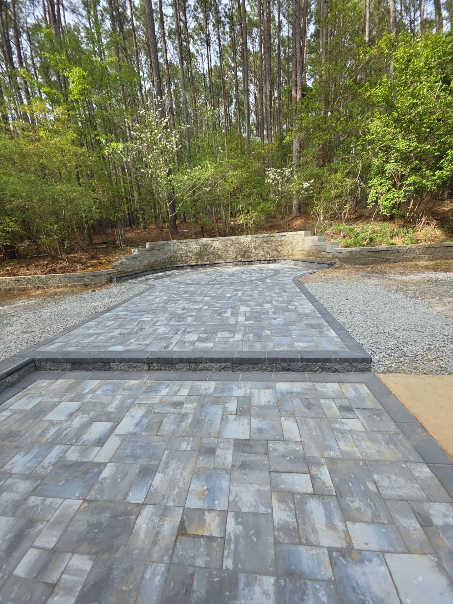 Pittsboro Outdoor Living Transformation – Retaining Wall, Paver Patio & Elevated Deck by Elite Remodeling and Design LLC