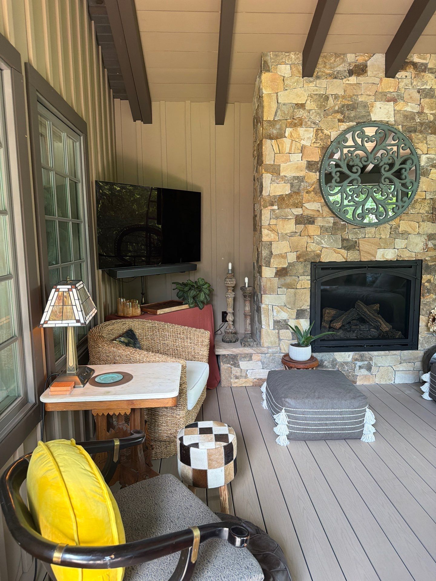 Custom Composite Deck with Stone Fireplace and Modern Cable Railing by Walnut Hollow Decks & Outdoor Living
