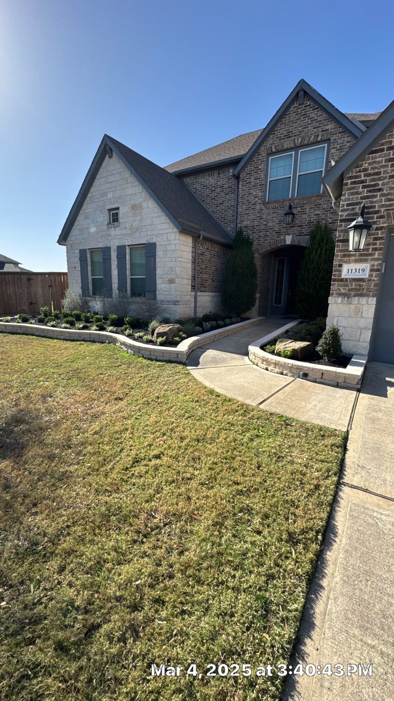 🌿✨ Darlene & Andrew’s Amazing Curb Appeal Transformation  Some projects are more than just landscaping—they’re a conversion of curb appeal from the ground up. For Darlene & Andrew, Alejandro and the Texas Urban Team designed and delivered a complete solution that reshaped their flower beds, solved drainage challenges, and gave new life to the sideyard.  💡 From planning to execution, every step was tailored to build both beauty and functionality:  🌸 Flower Beds, Reinvented  Demolition of old beds, plants, and mulch.  Fresh soil preparation, weed protection, and a brand-new retainer wall built with hand-cut stone and decorative caps.  Carefully selected plants and garden mix to ensure health and visual harmony.  💧 Drainage & Irrigation Upgrades  Outdated corrugated pipes replaced with PVC drainage lines to carry water safely away from the foundation.  New irrigation system combining drip lines and sprinklers—watering plants while keeping the house walls protected.  Sideyard drainage extended with catch basins and PVC piping to prevent water pooling and foundation stress.  🚶 Functional Sideyard with Walkway & Trash Area  Graded and leveled sideyard to manage runoff.  Installed a modern gravel and paver walkway for easy access.  Built a firm and tidy concrete-paver pad for trash containers—making the space both practical and polished.  🛠️ Stonework & Craftsmanship  Every stone in the retainer wall was cut, set, and secured by the team of handcrafters, ensuring a durable build that doubles as a design statement.  ✅ Outcome: Darlene & Andrew’s property now has better drainage, a clean and organized sideyard, and elegant new flower beds—all designed for long-term durability and lasting beauty.  📢 Before hiring anyone, review our portfolio. Our work speaks louder than words—each project is a blend of function, protection, and design crafted to last. by Texas Urban Elements