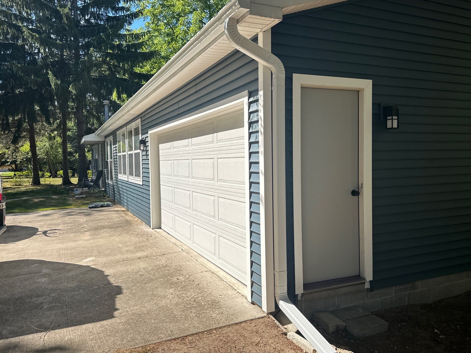 Residential White Gutter and Downspout Installation in Charlevoix by Rainbow Seamless Systems