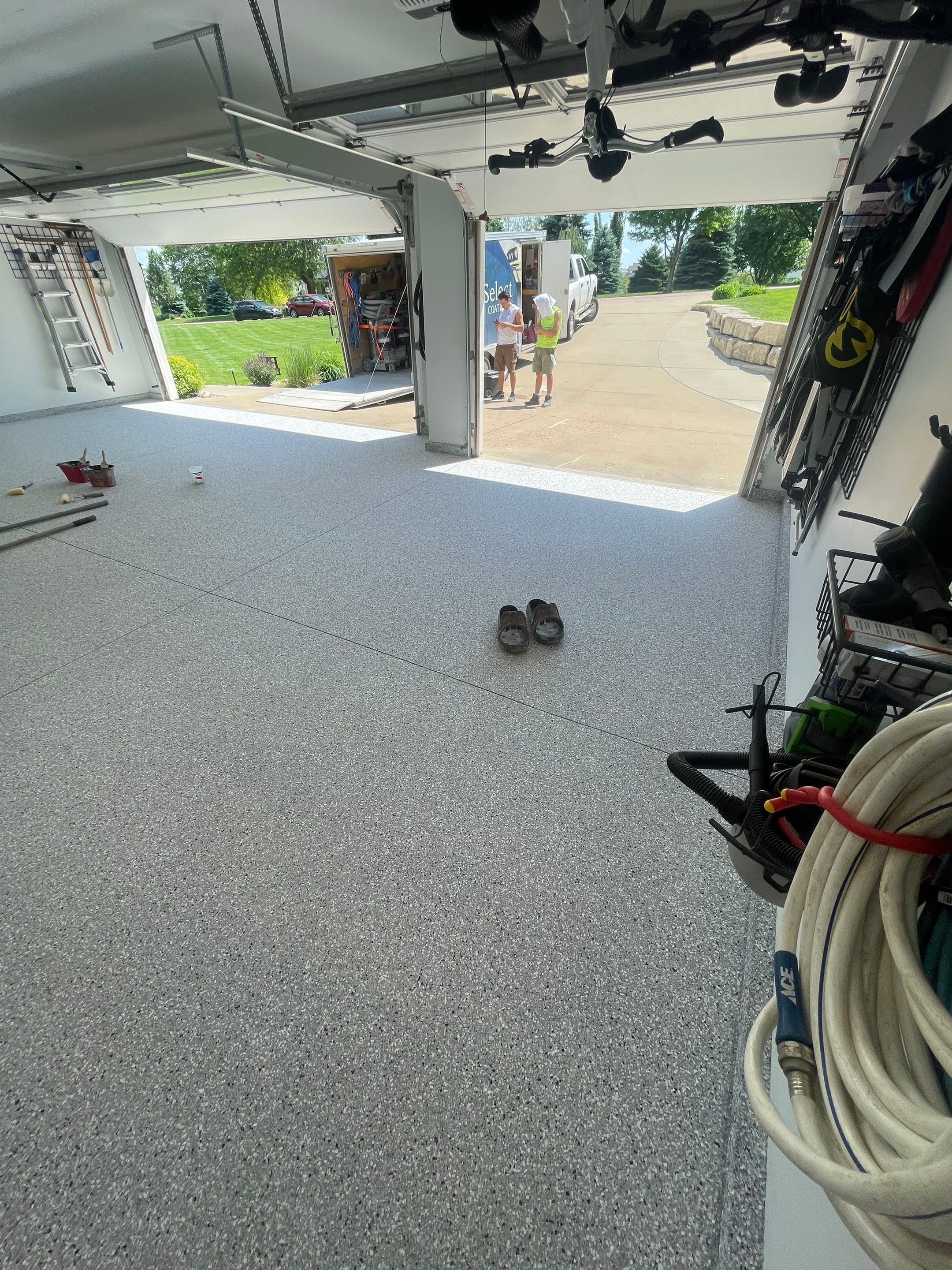 Feather Grey Garage Floor Coating Installation in Sioux Falls by Select Painting, Coatings & Garage Cabinets