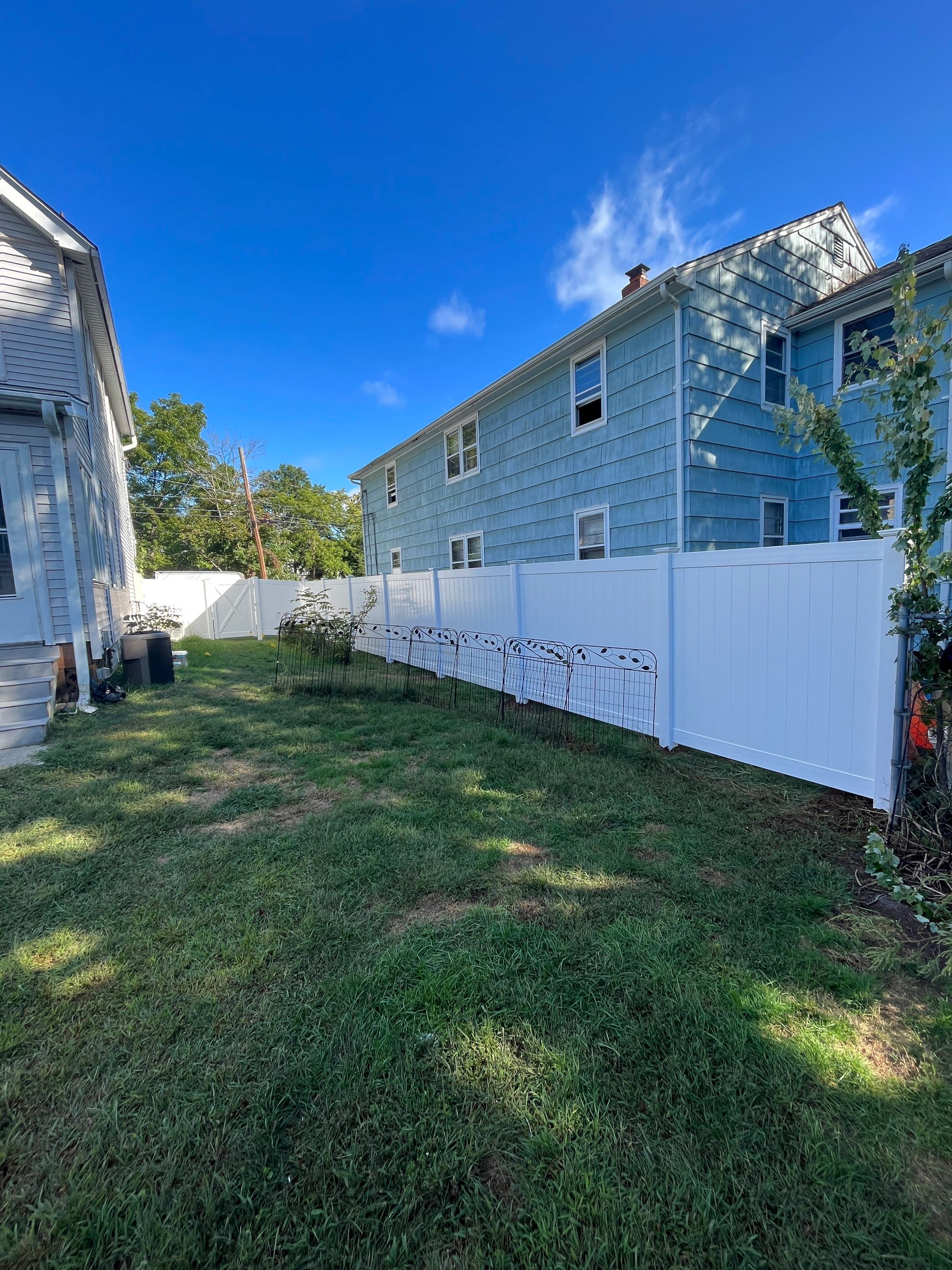 Vinyl Privacy fence with matching gate, White by DiGiorgi Roofing and Siding Inc