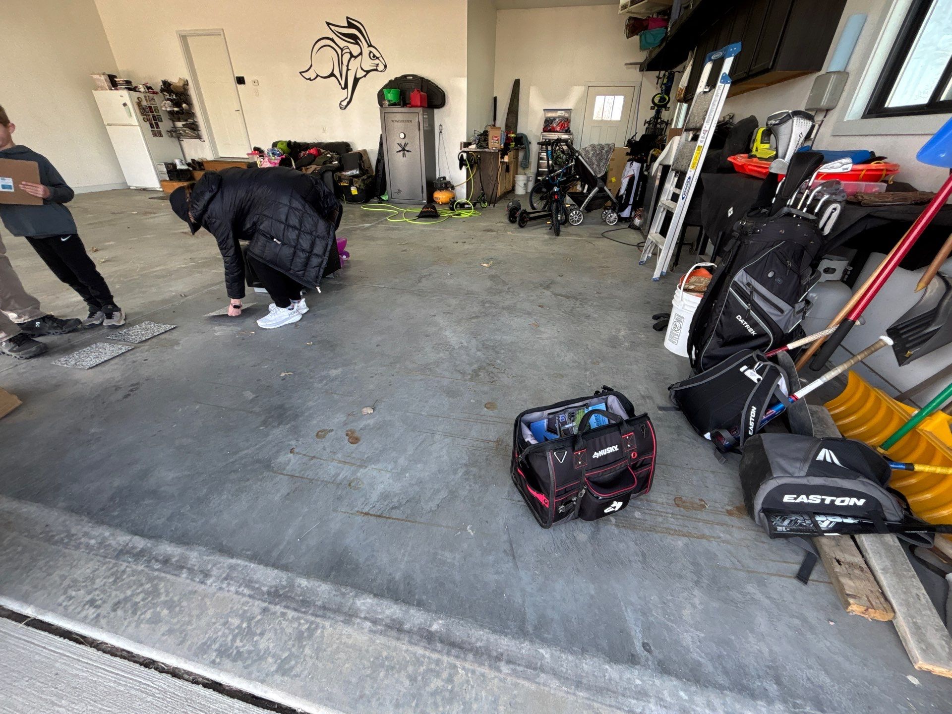 Speckled Polyaspartic Garage Floor Coating Installation in Dell Rapids by Select Painting, Coatings & Garage Cabinets
