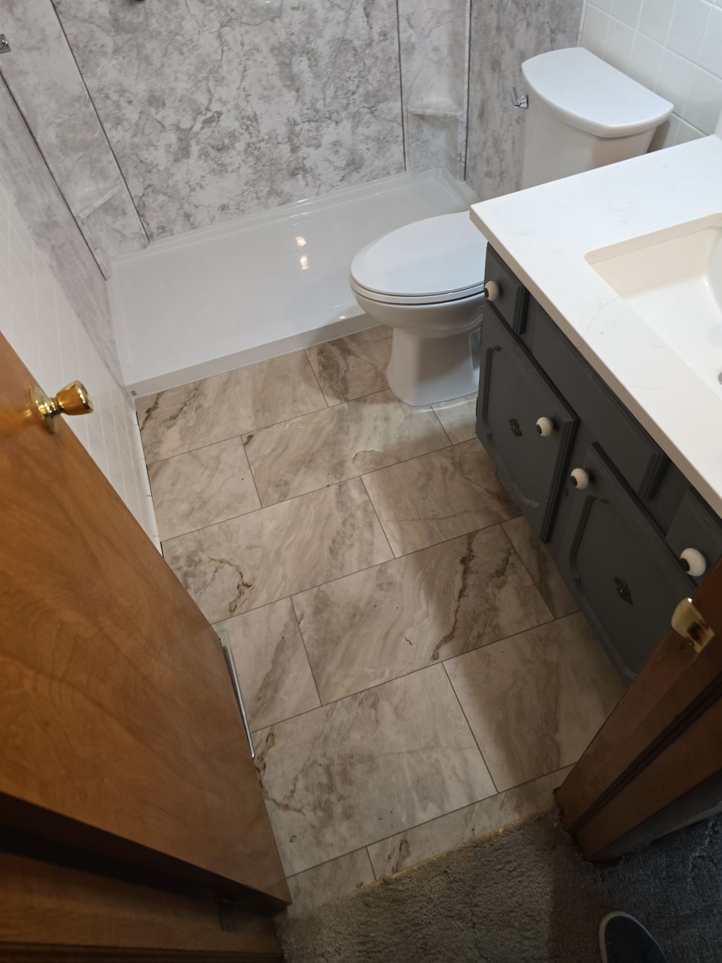 Tub to Shower , flooring, and countertop by The Shower Company