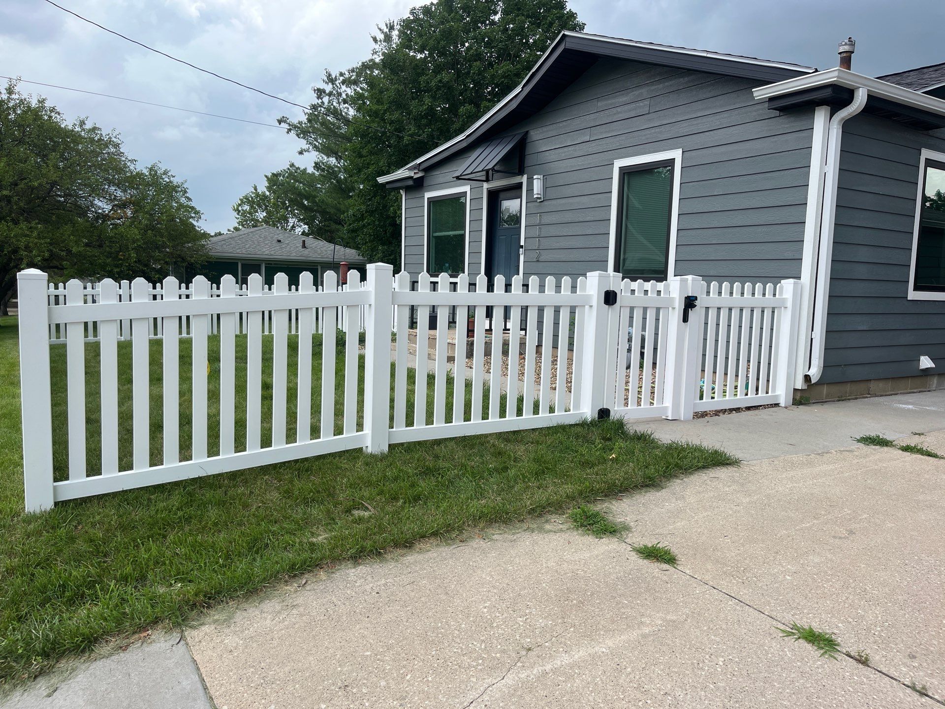 White Vinyl Spaced Picket Fence Installation in Cedar Falls by Perfect Picket Fence and Stain