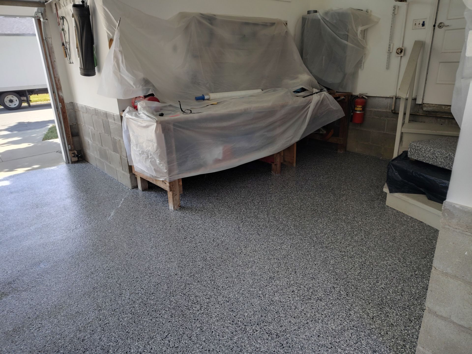Wombat Flake Garage Floor Coating in Perry, IA by Revival Concrete Coatings