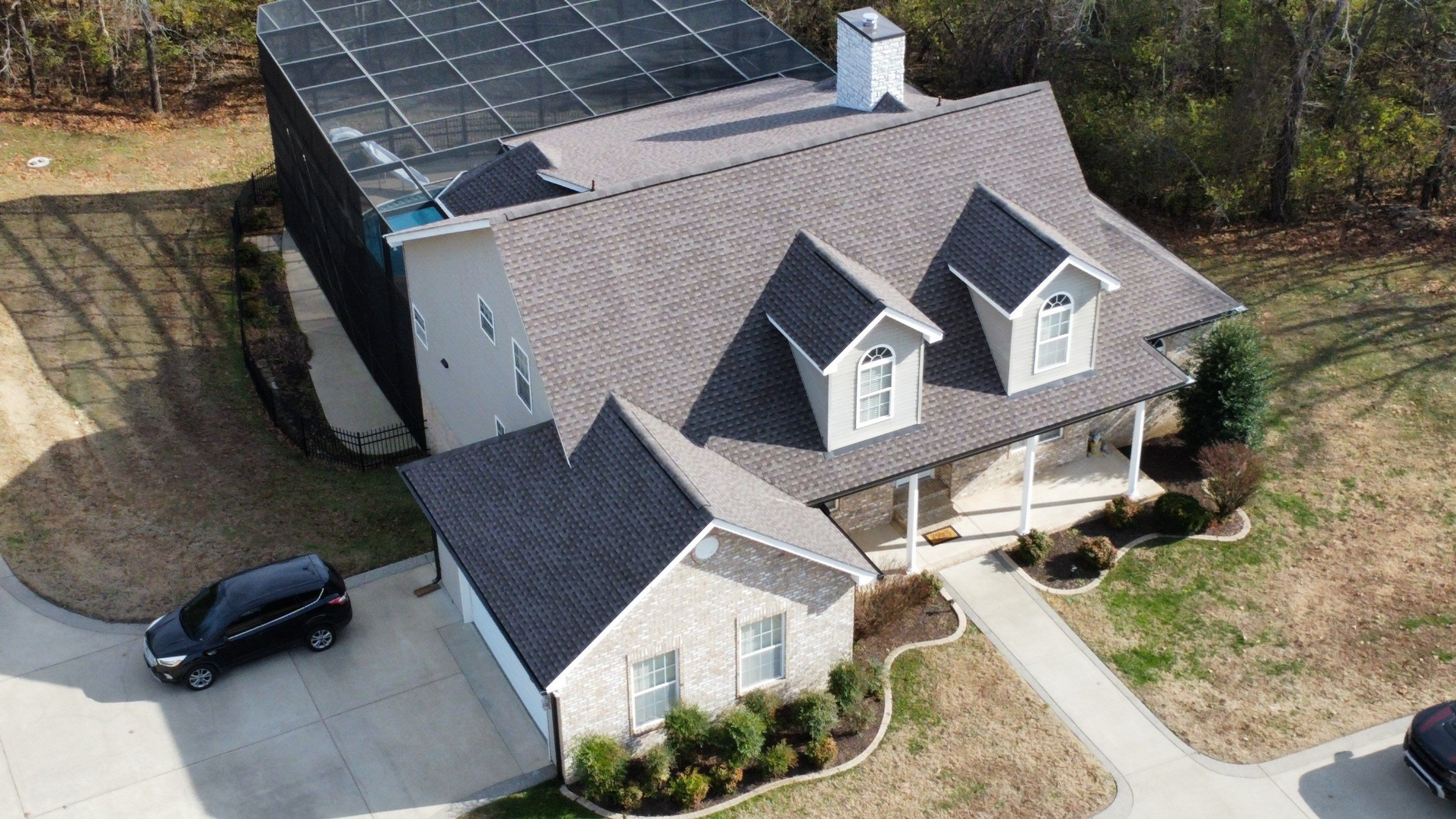 Roof and Gutter System Replacement with Stone Chimney Rebuild by Undersun Roofing 