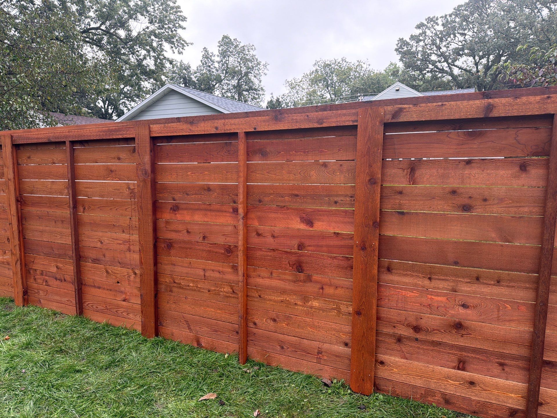 Stained Horizontal Cedar Wood Privacy Fence in Cedar Falls by Perfect Picket Fence and Stain
